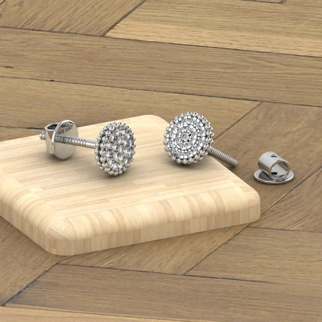 A pair of 18K gold natural diamond cluster stud earrings placed on a wooden surface.