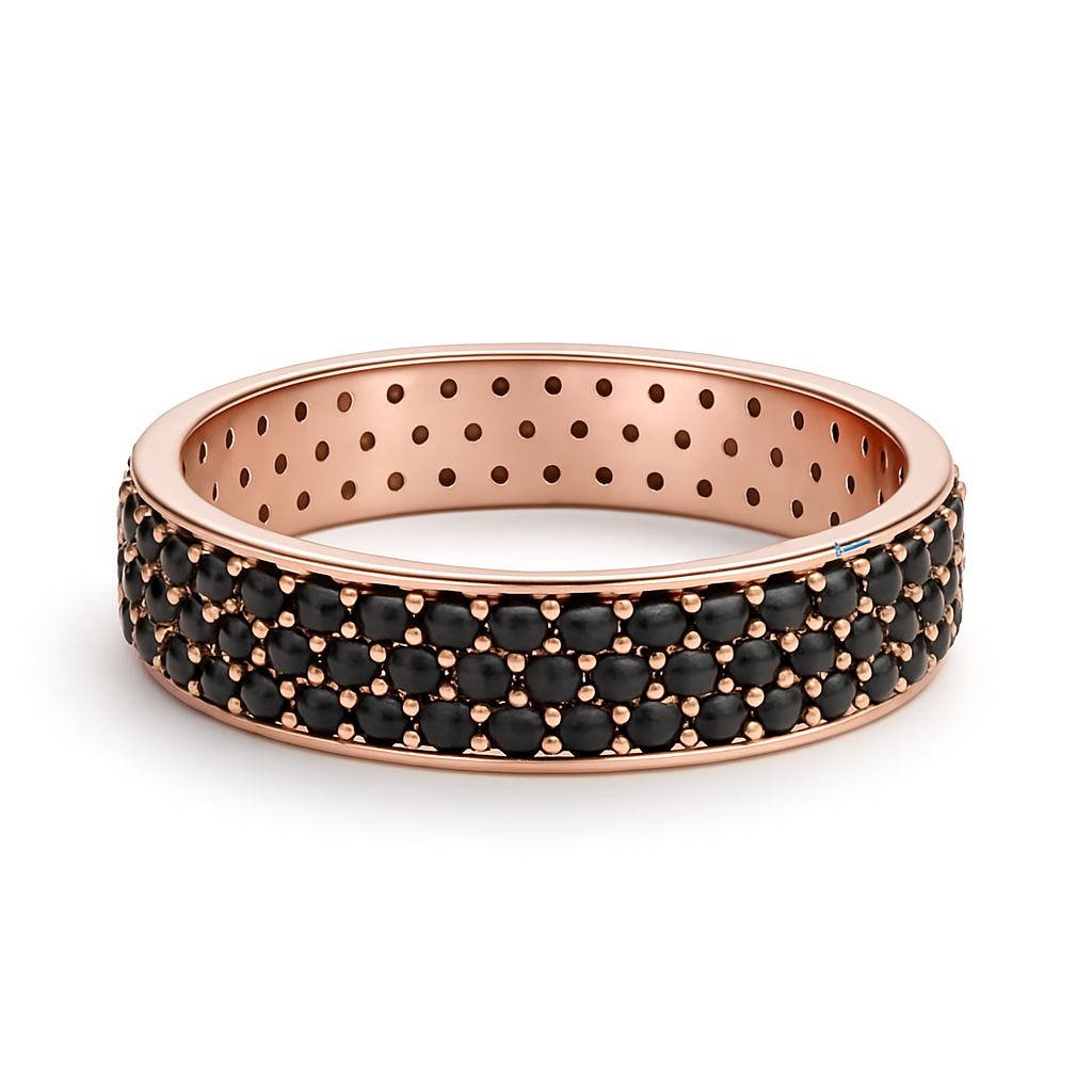 Rose gold ring with black gemstones on a white background
