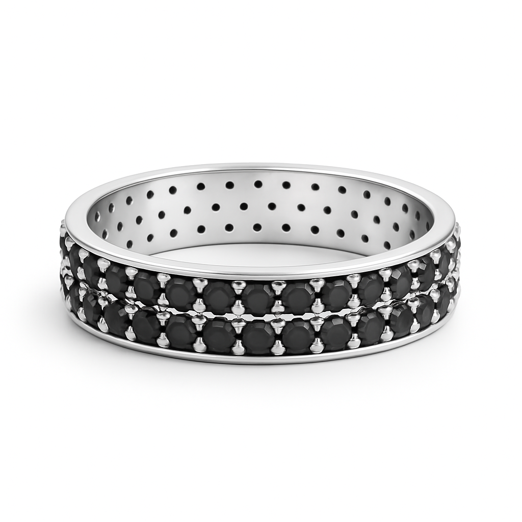 Silver ring with black gemstones on a white background