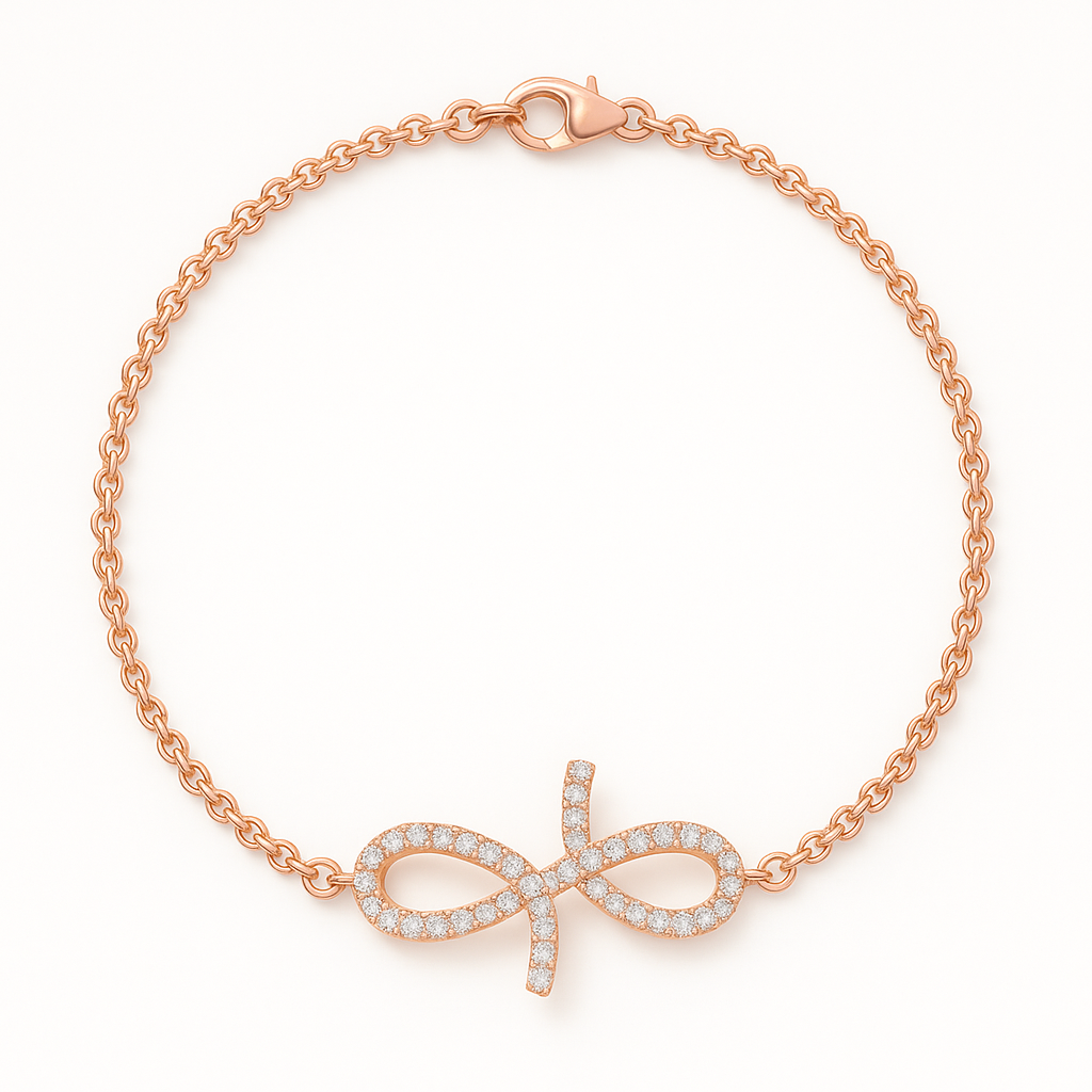 Rose gold bracelet with bow charm on a white background