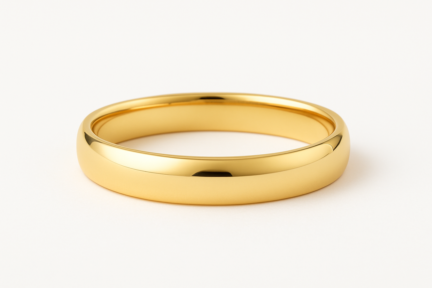 Gold wedding band ring on a white background