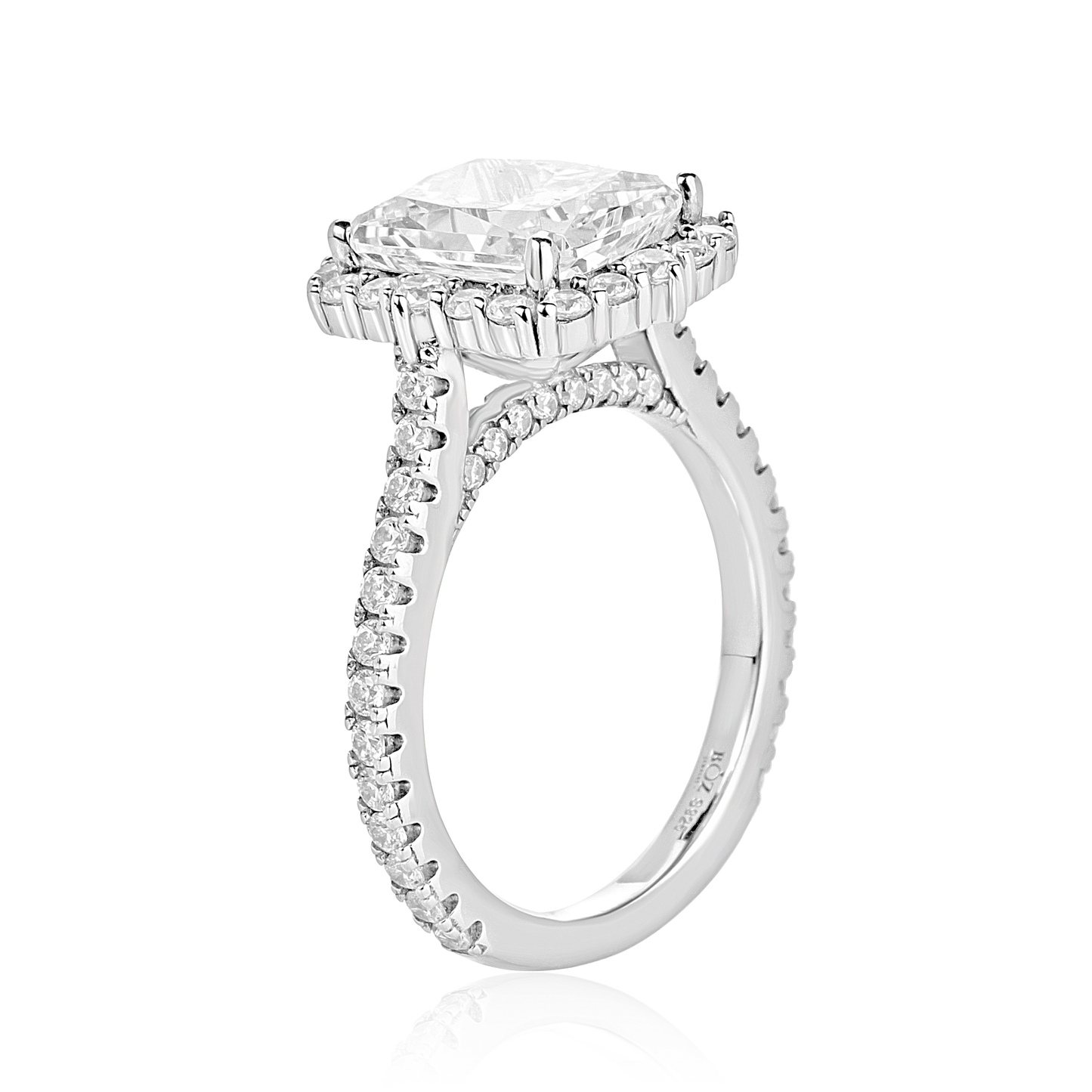 Diamond ring with a central pear-shaped gemstone and smaller diamonds on a white background