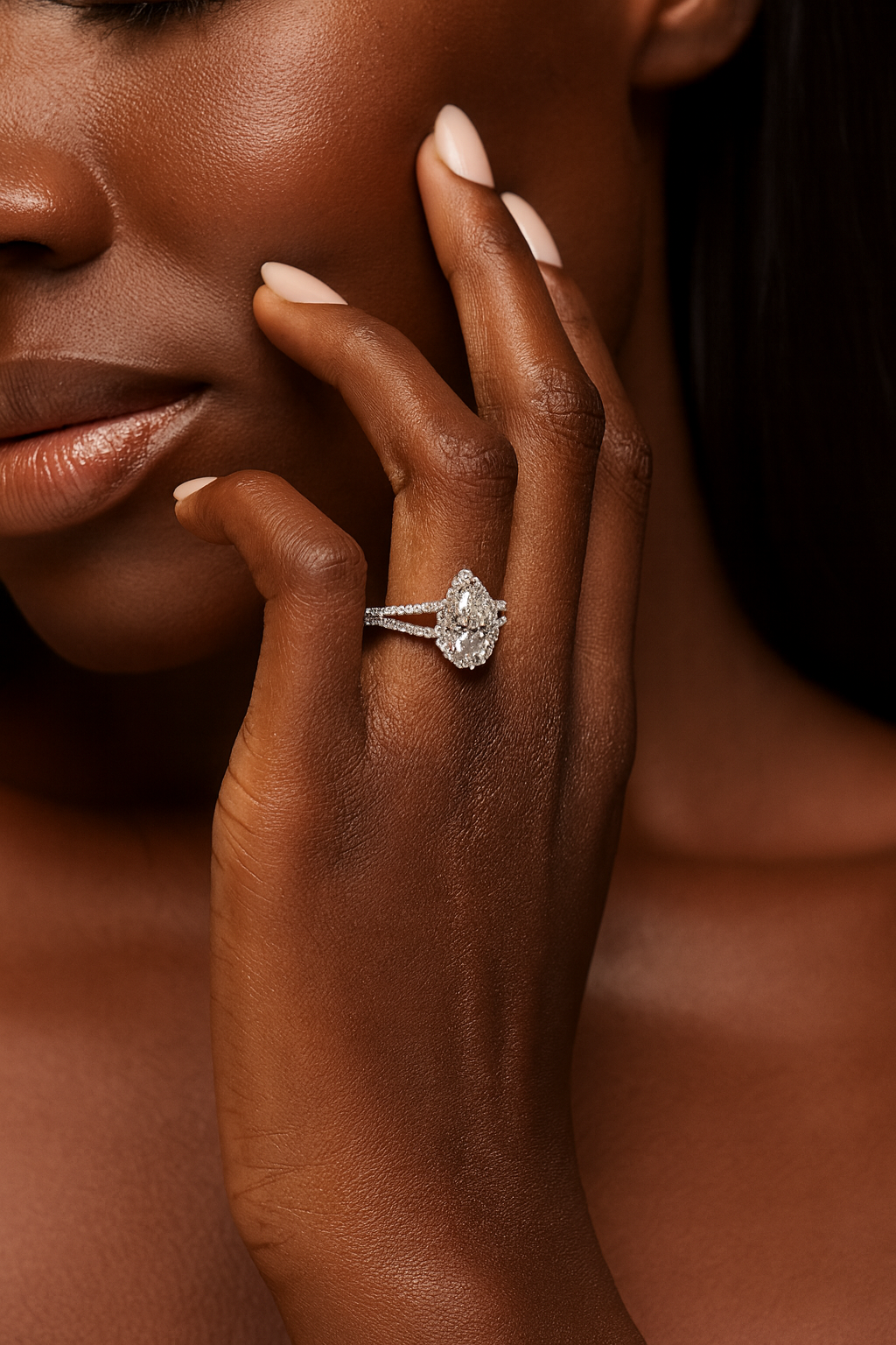 Close-up of a hand with a diamond ring on a dark background