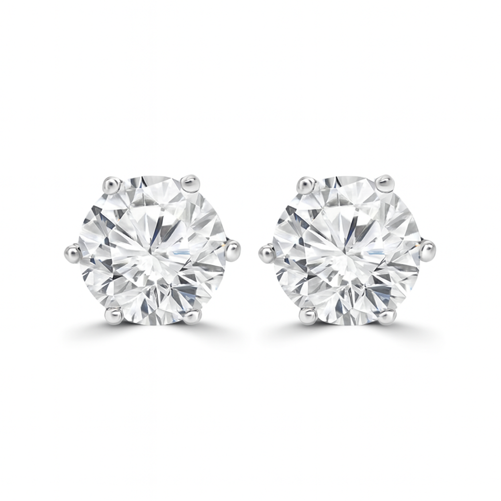 Pair of diamond stud earrings on a white background