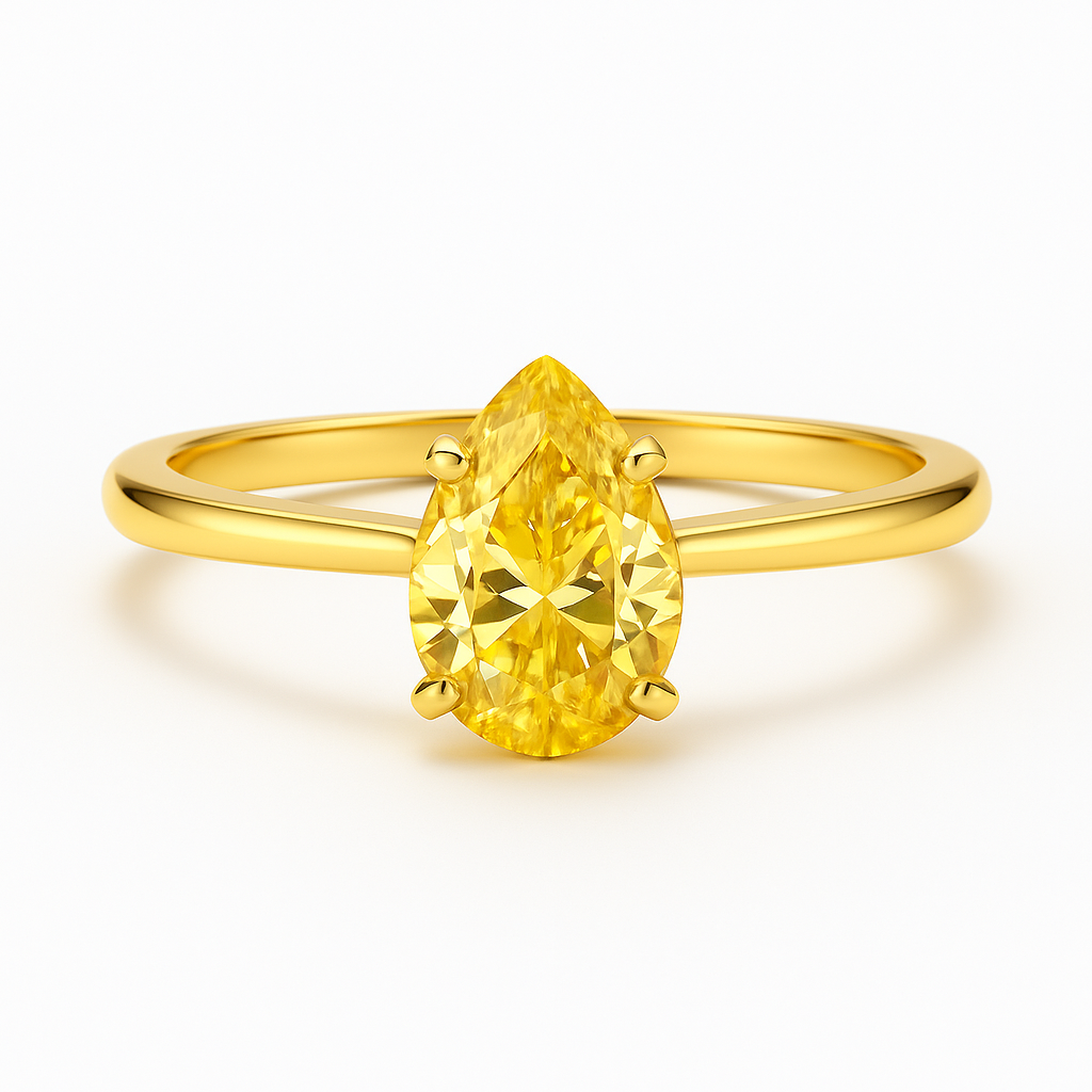 Gold ring with a yellow pear-shaped gemstone on a white background
