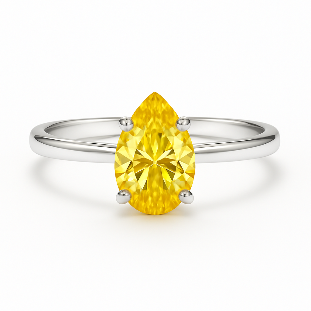 Ring with a yellow pear-shaped gemstone on a white background