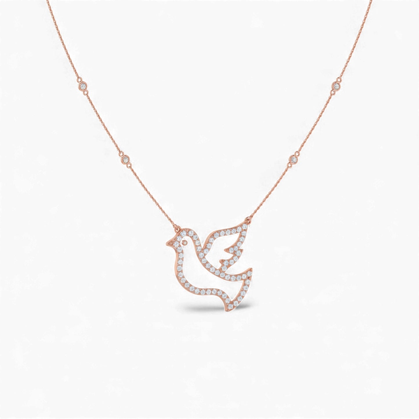 Rose gold necklace with a dove-shaped pendant on a white background