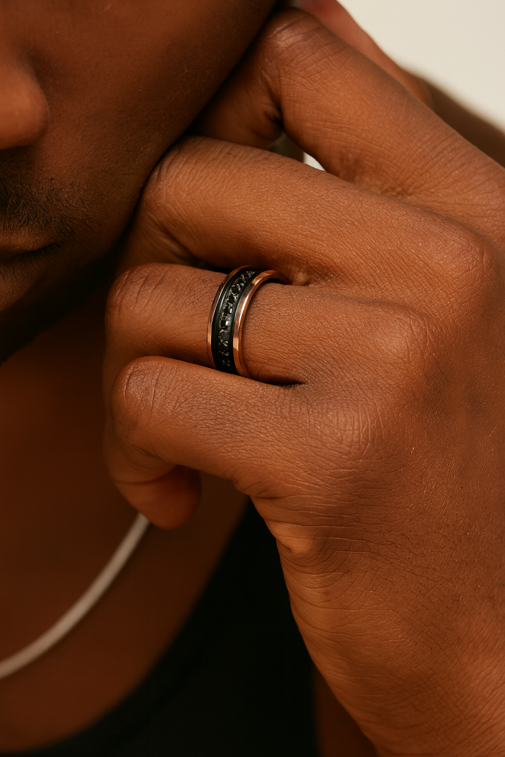 Close-up of a hand wearing a ring with a blurred background