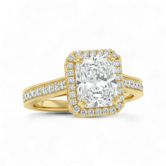 Gold ring with a large diamond and smaller diamonds on the band against a white background