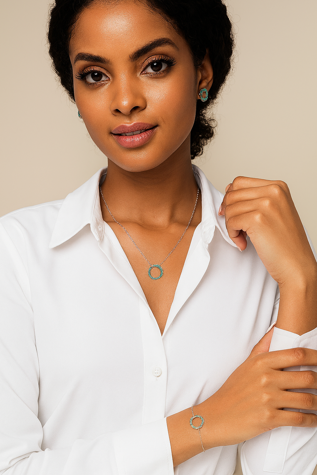 Woman wearing a necklace and bracelet with a plain background
