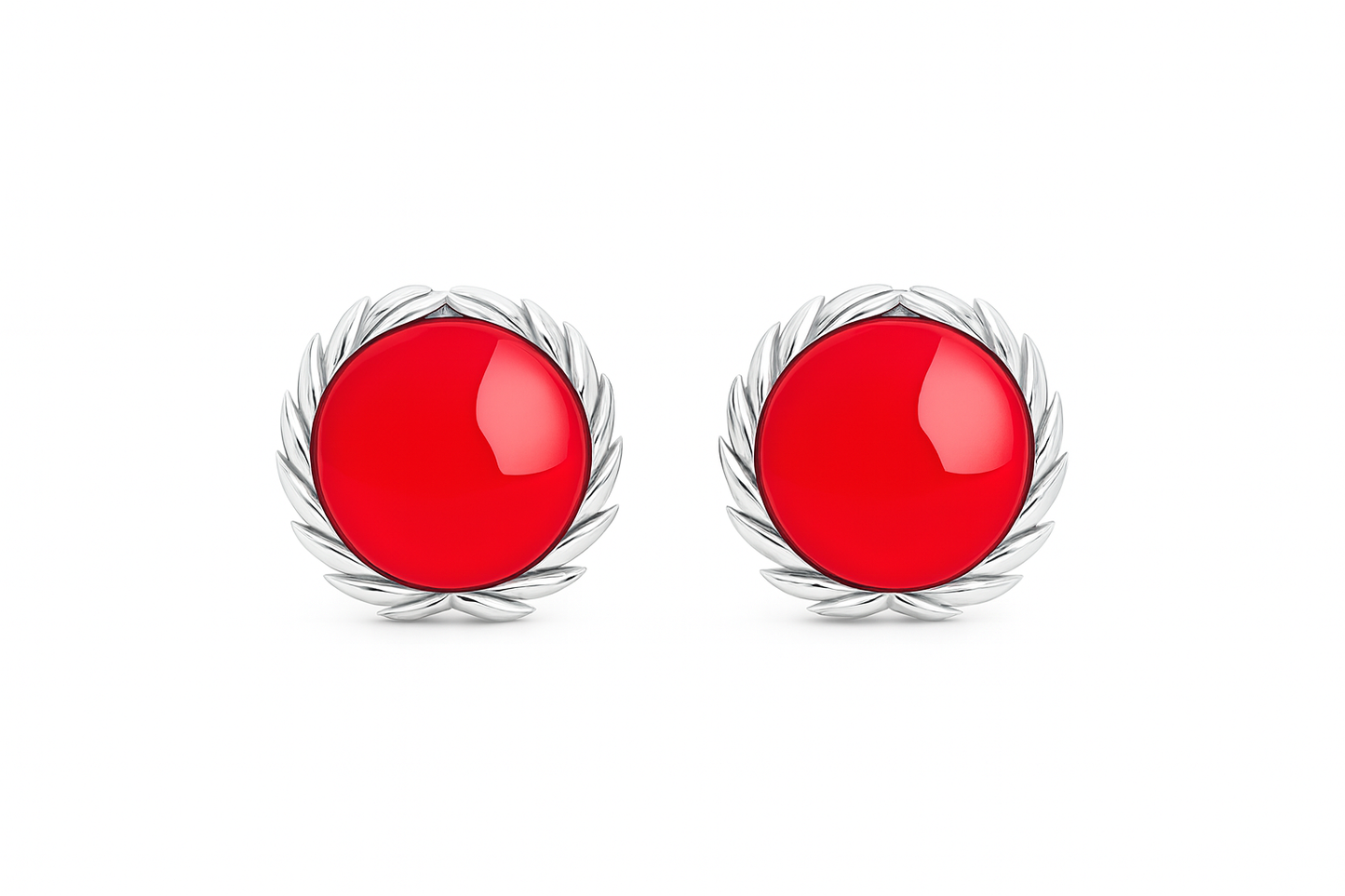 Pair of earrings with red circular stones and silver wire-like designs on a white background