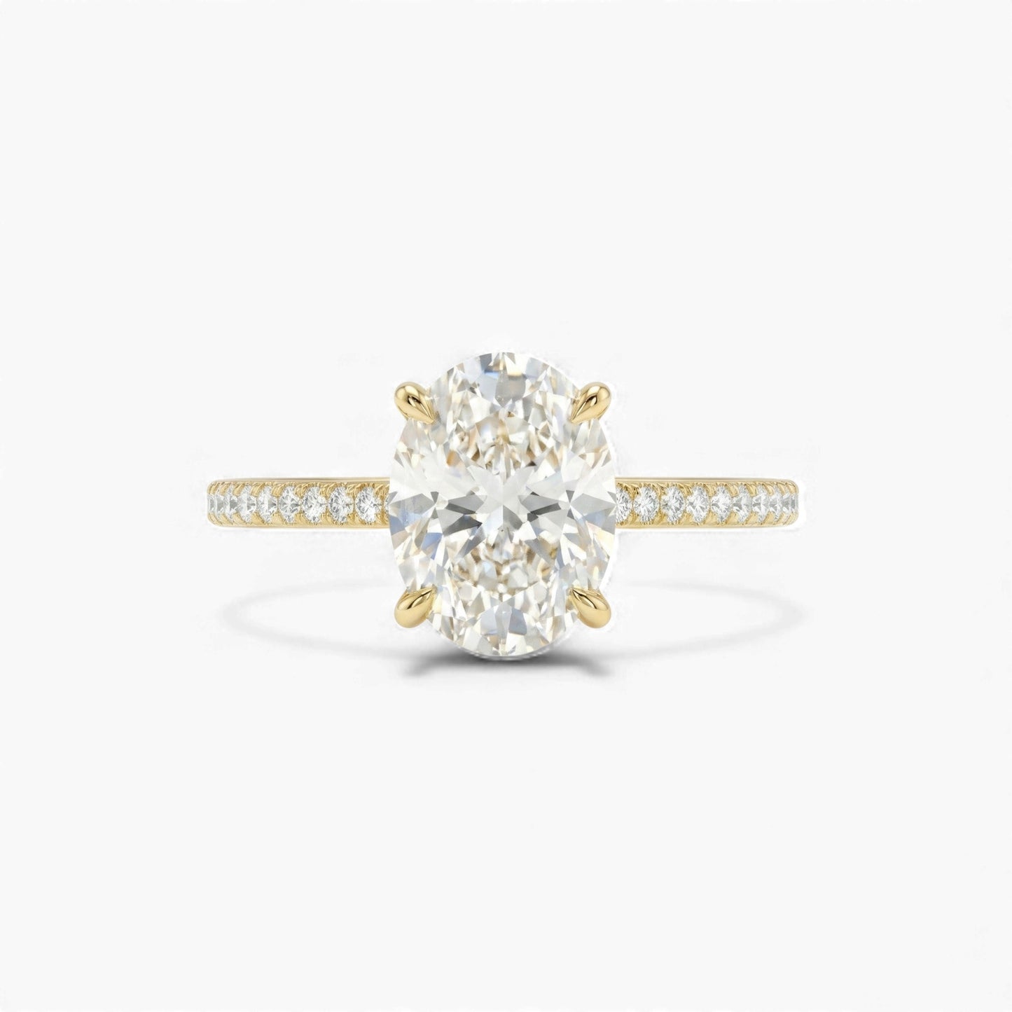 Gold ring with a large diamond and smaller diamonds on the band against a white background