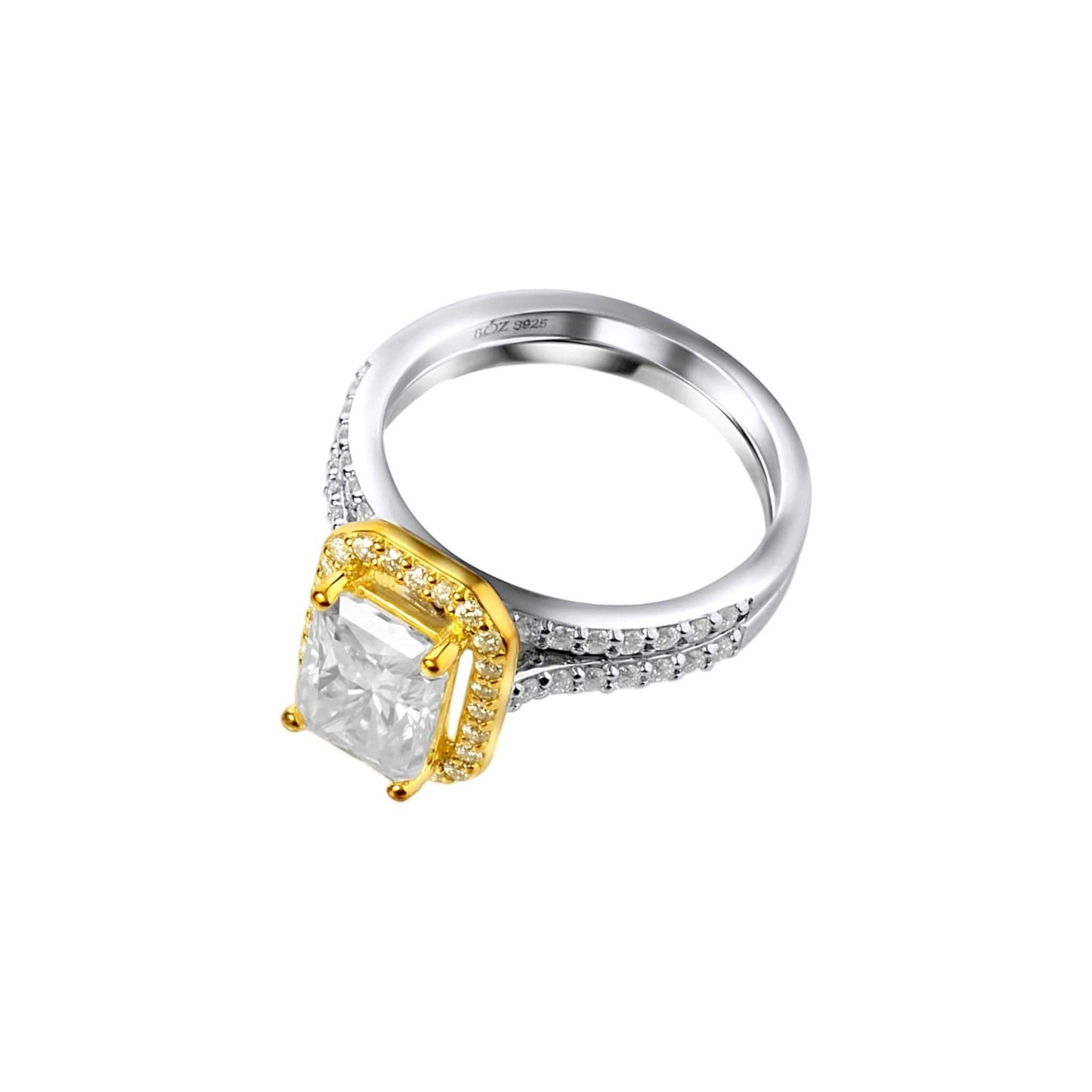 Two-tone ring with a large central diamond and smaller diamonds on the band against a white background