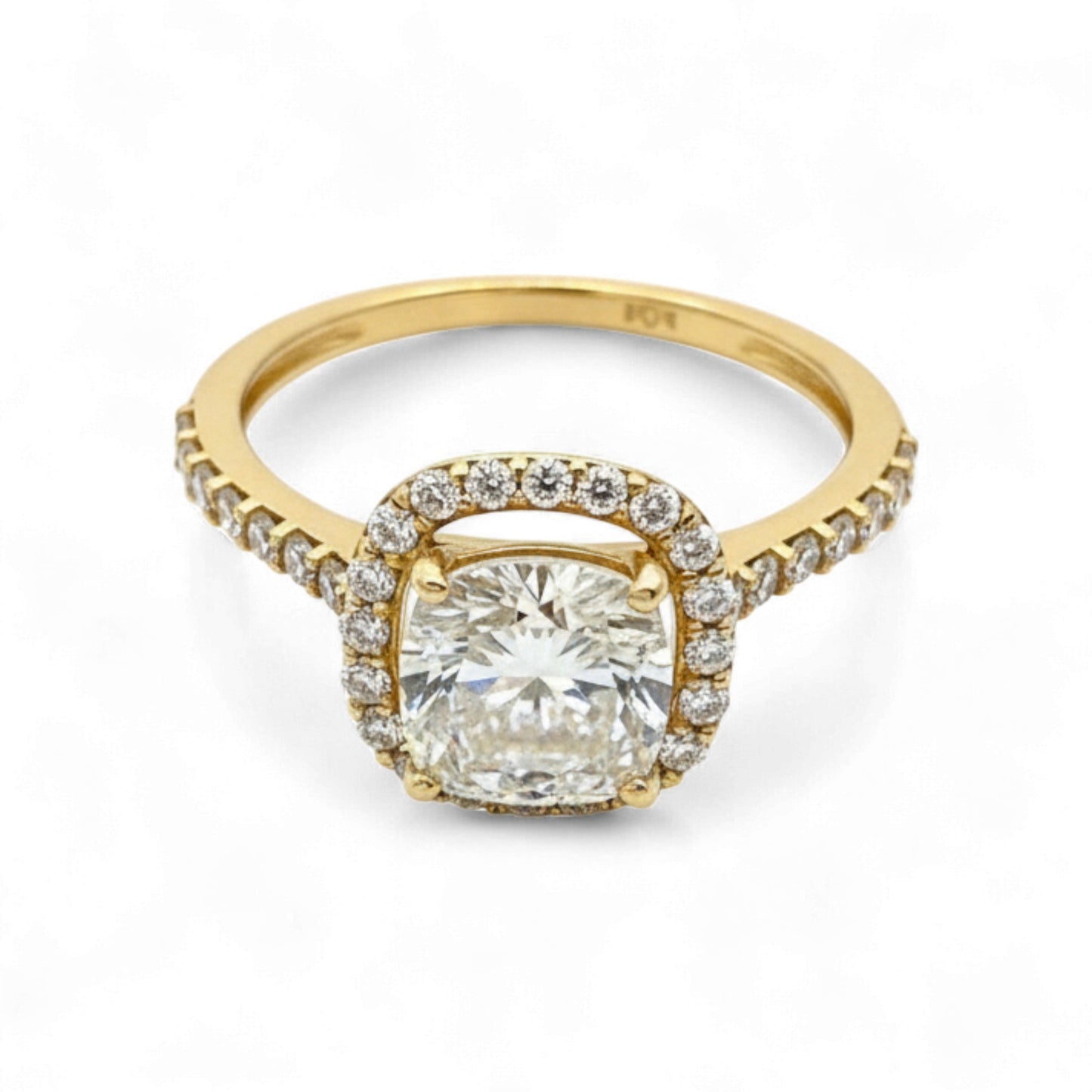 Gold ring with a large diamond and smaller diamonds on the band against a white background