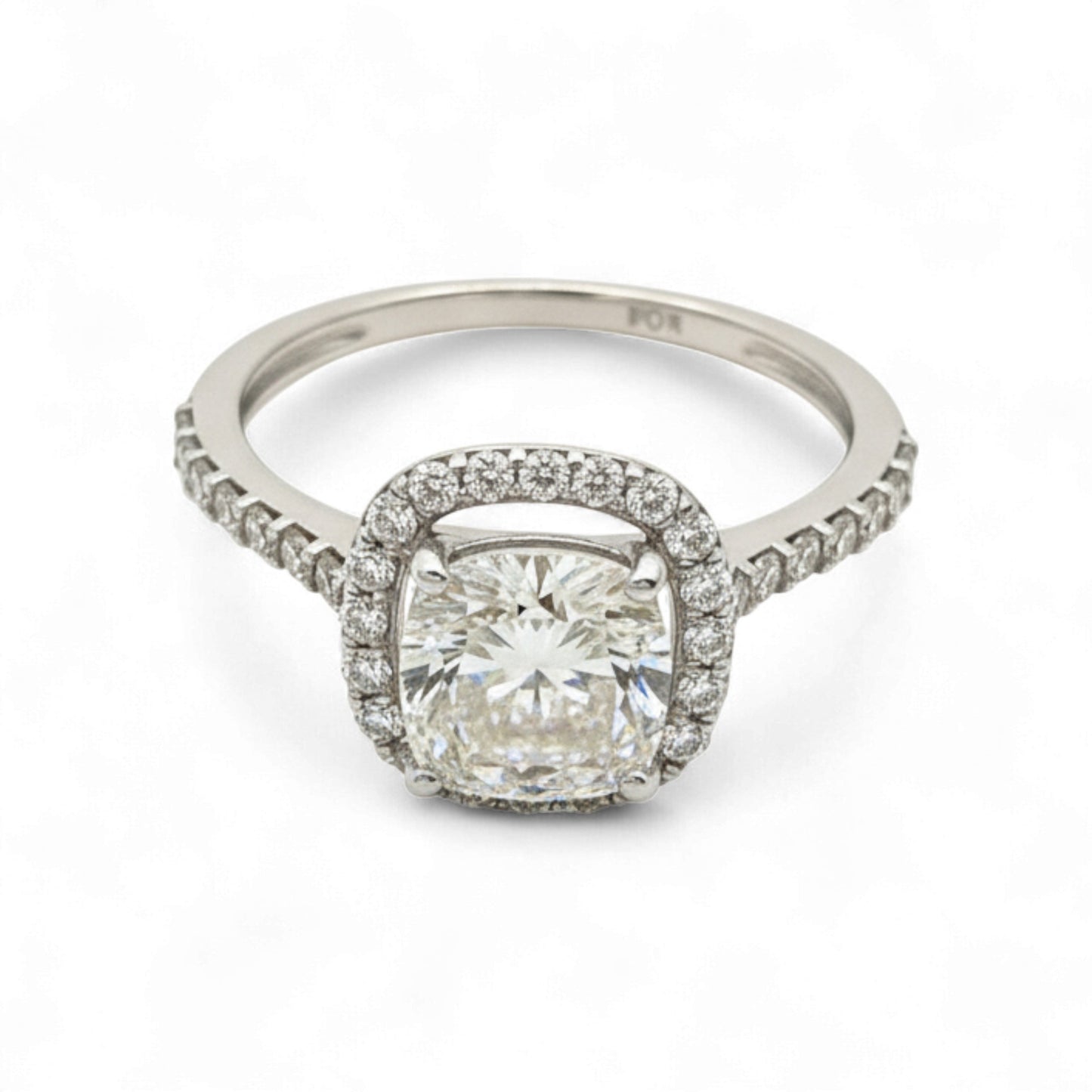 Diamond ring with a cushion-cut center stone and diamond halo on a white background