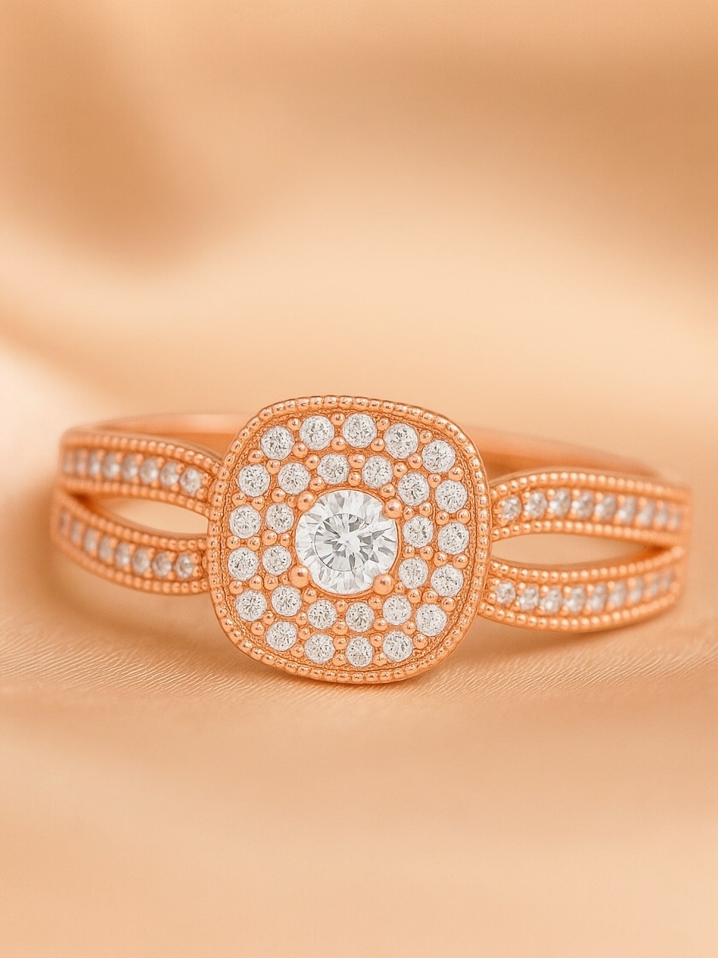Rose gold ring with diamond accents on a peach background