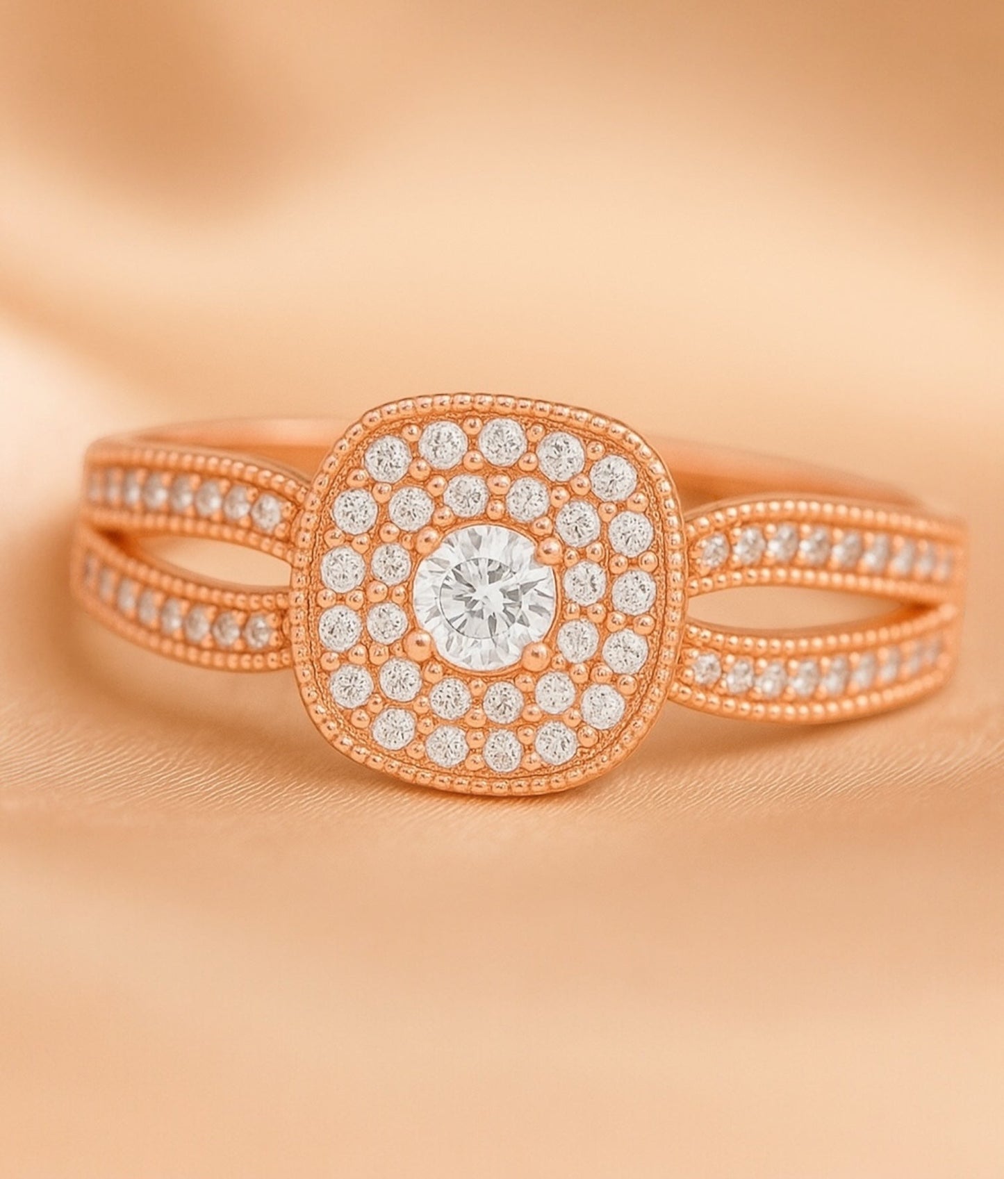 Rose gold ring with diamond accents on a peach background