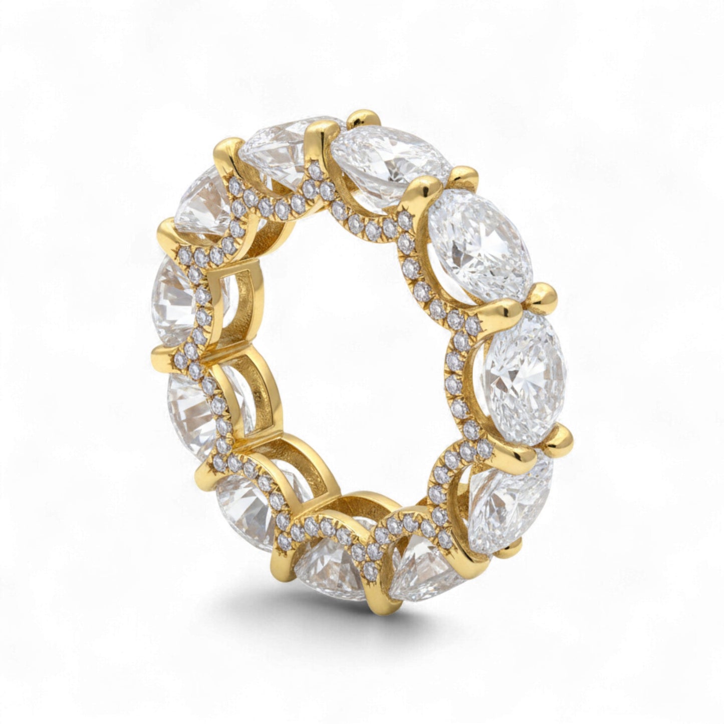Gold ring with clear gemstones on a white background