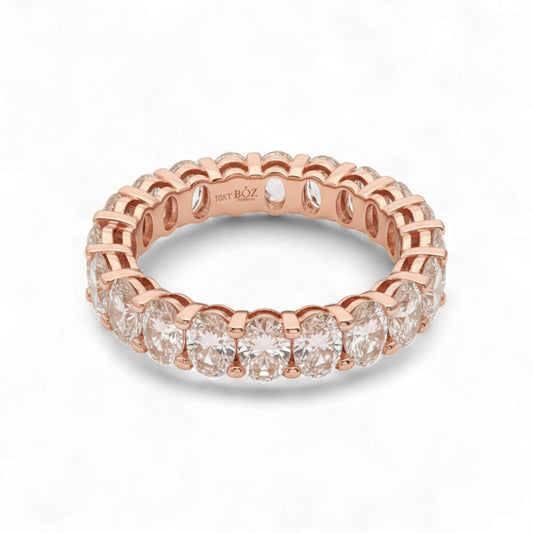 Rose gold ring with diamonds on a white background
