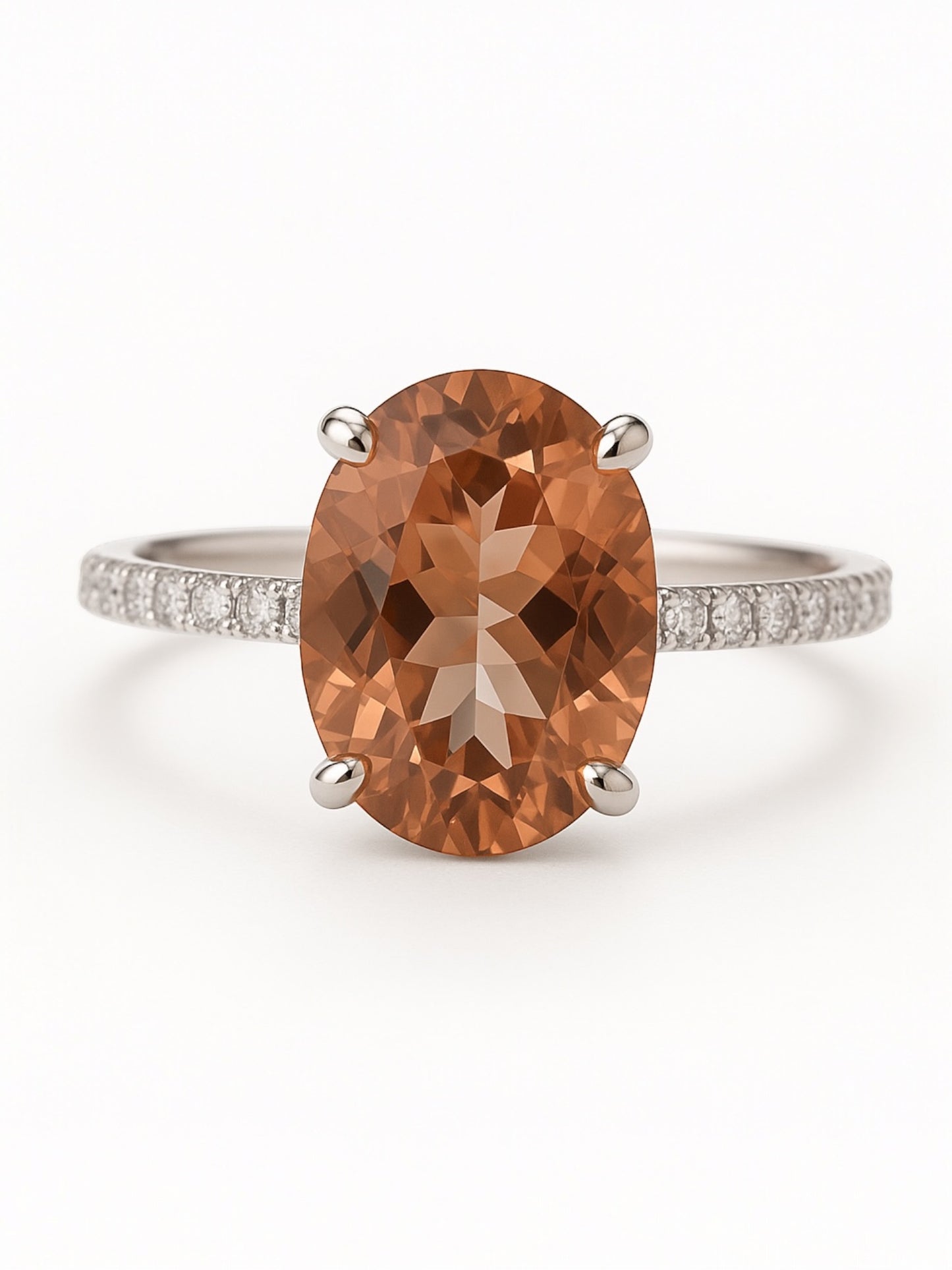 Ring with a large brown gemstone and smaller diamonds on a white background