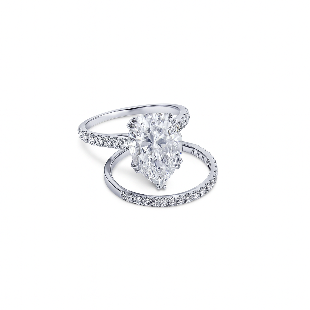 Diamond ring with pear-shaped center stone on a white background