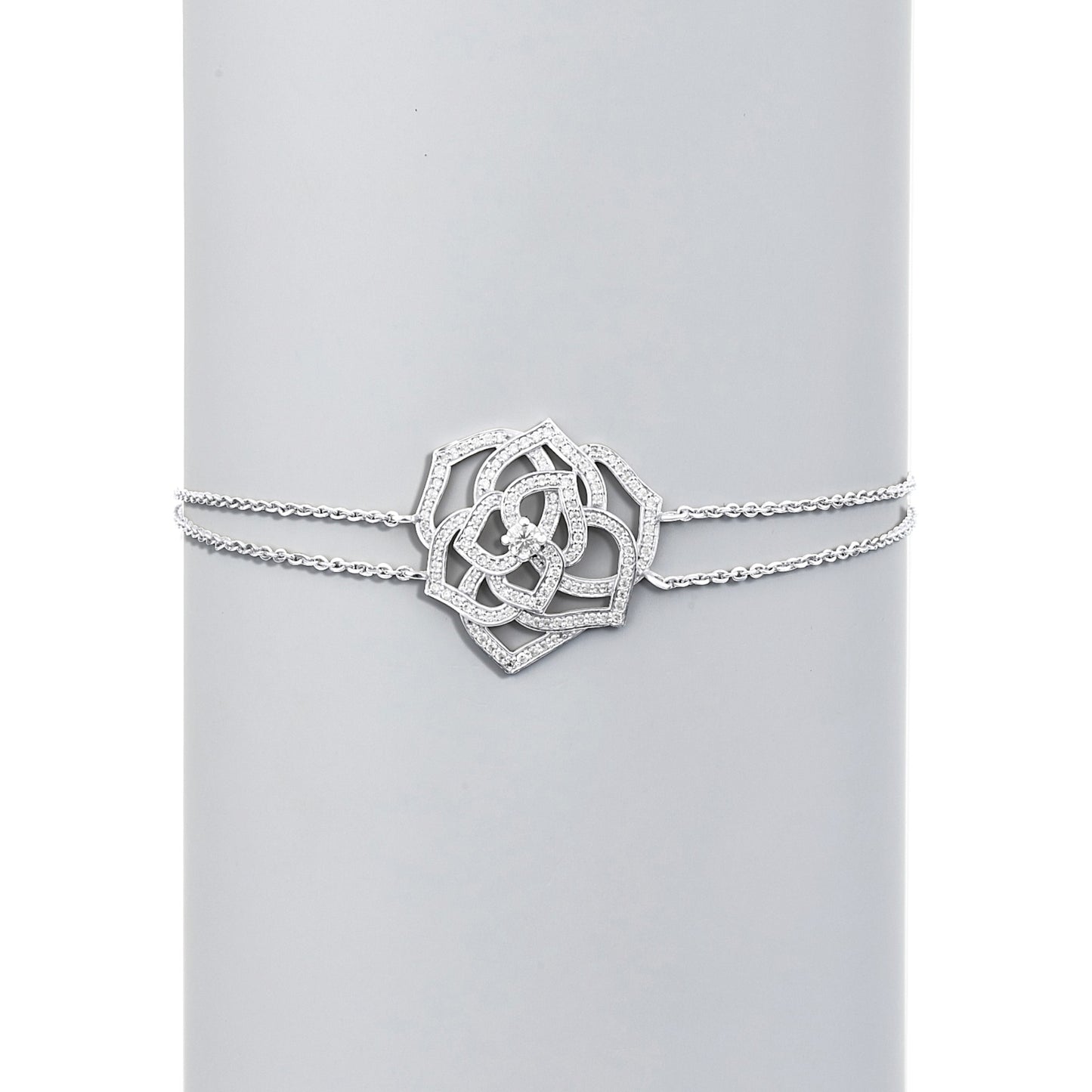 Silver bracelet with a decorative clasp on a light gray background