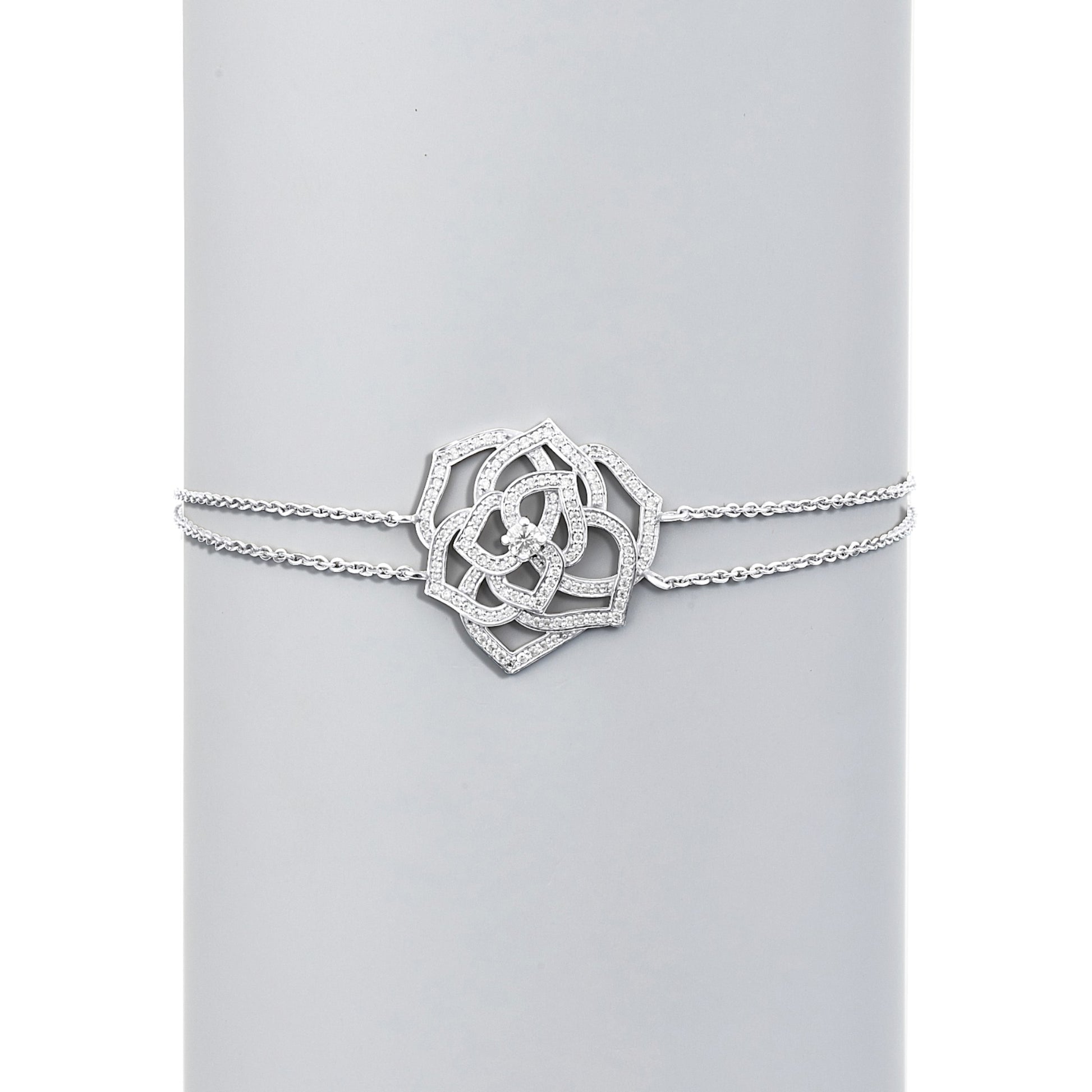 Silver bracelet with a decorative clasp on a light gray background