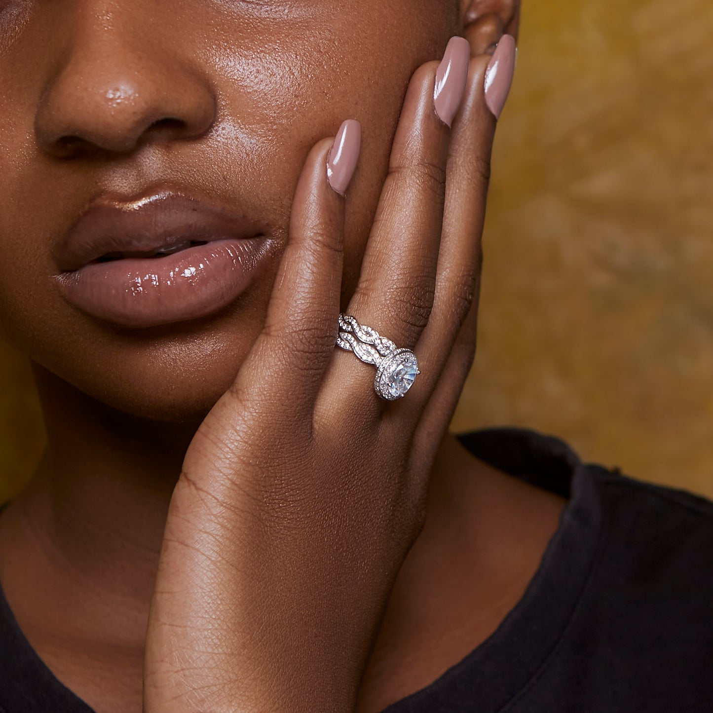 Close-up of a woman's hand wearing a diamond ring with a blurred background