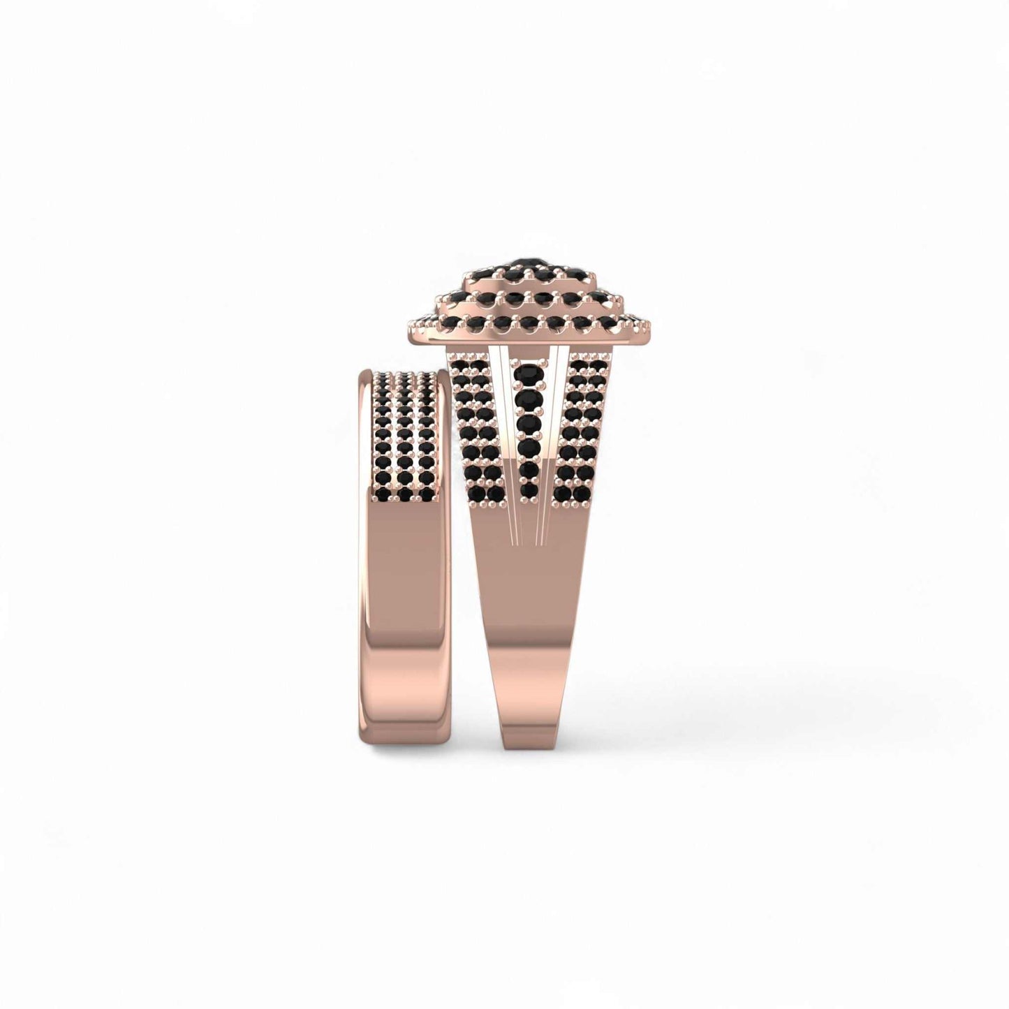Rose gold ring with black gemstones on a white background