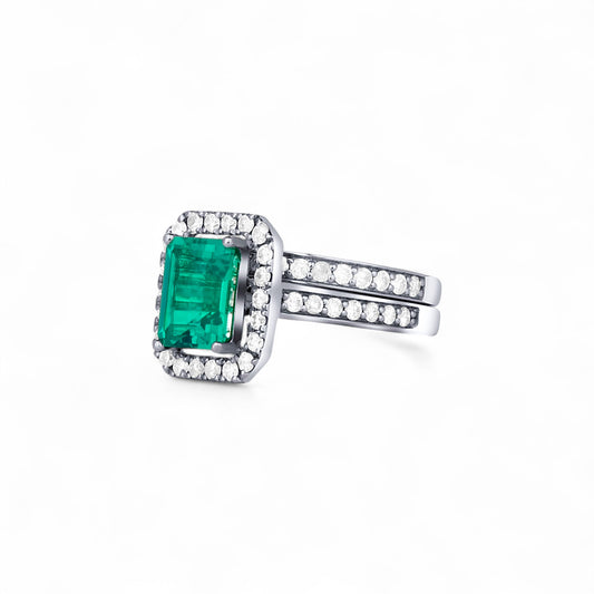 Silver ring with a green gemstone on a white background
