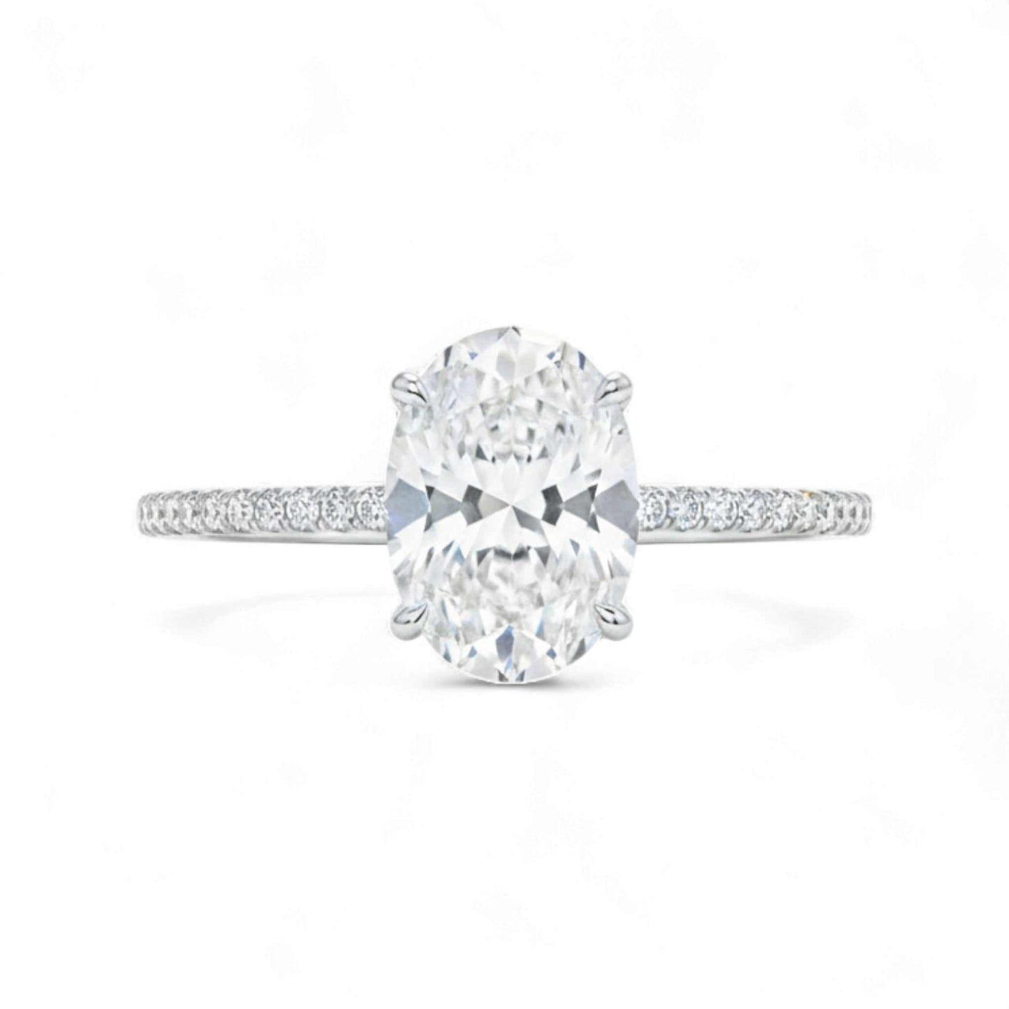 Diamond ring with a large central gemstone and smaller stones on the band against a white background