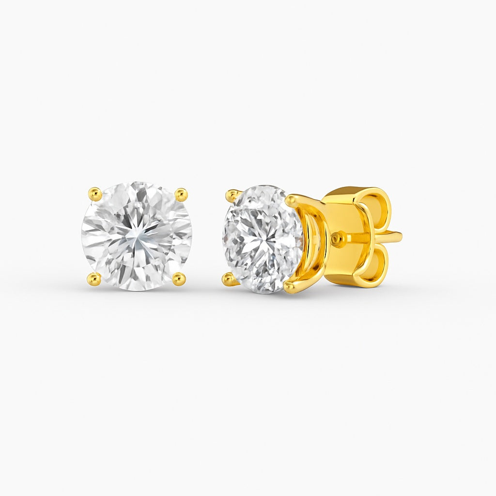 Gold stud earrings with clear gemstones on a white background