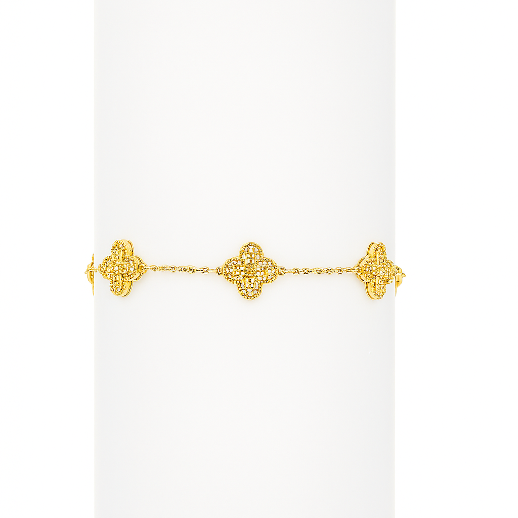 Gold bracelet with intricate design on a white background