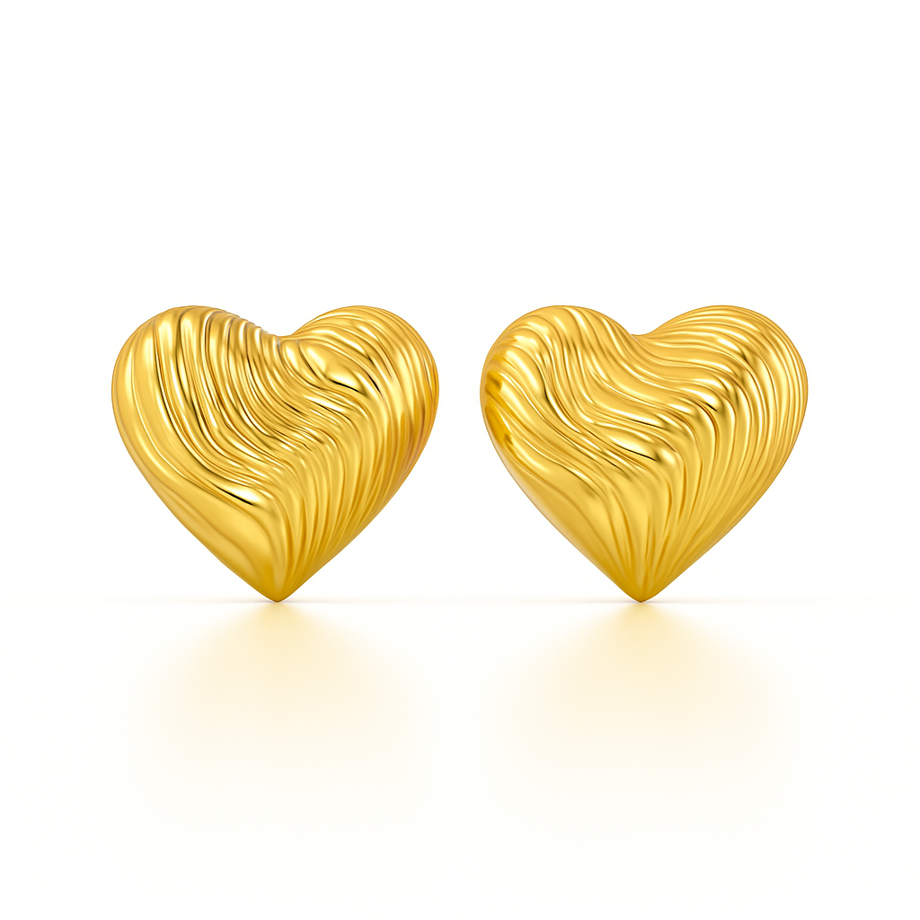 Gold heart-shaped earrings on a white background
