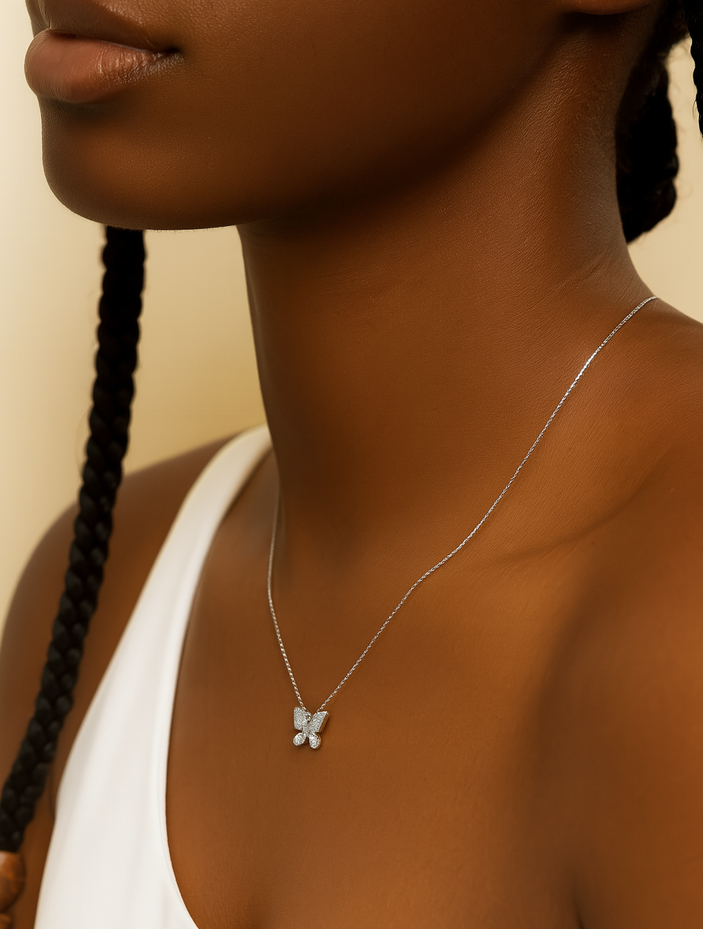 Butterfly necklace on a person with a neutral background