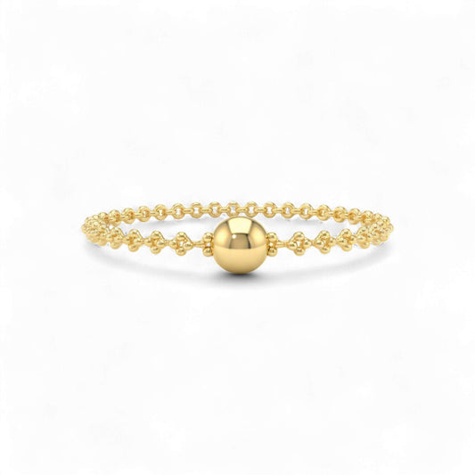 Gold bracelet with a round bead on a white background
