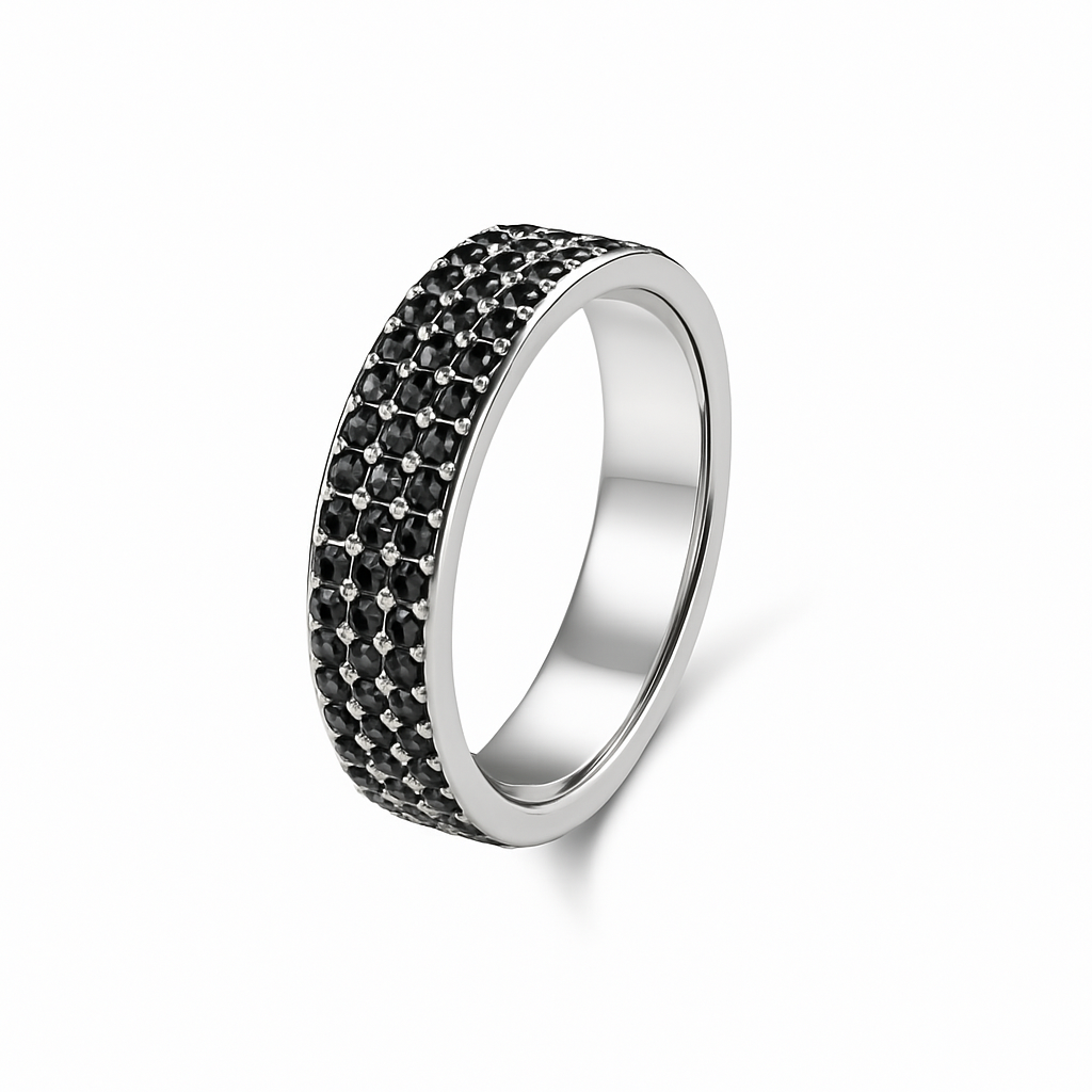 Silver ring with black gemstones on a white background