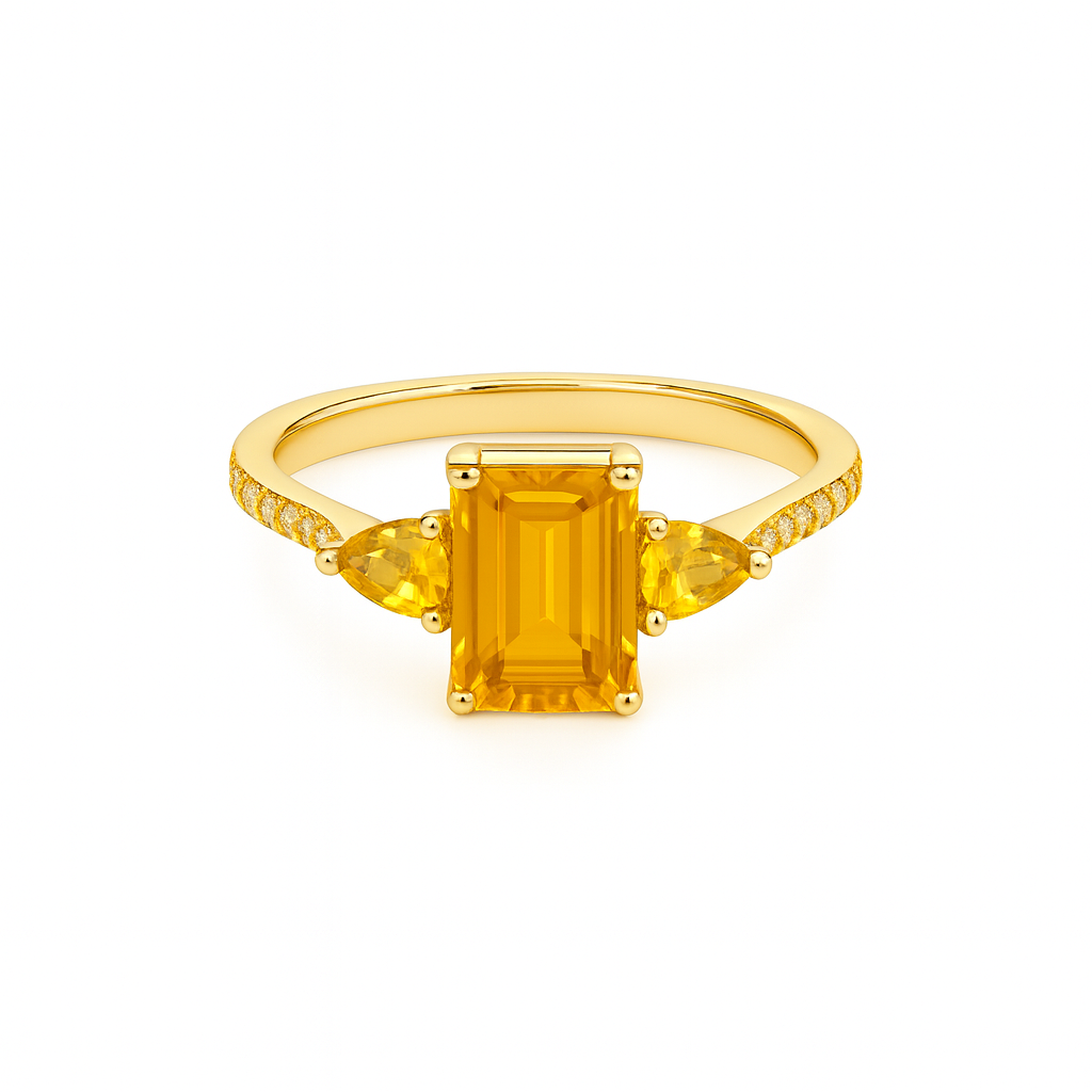 Gold ring with a rectangular yellow gemstone on a white background
