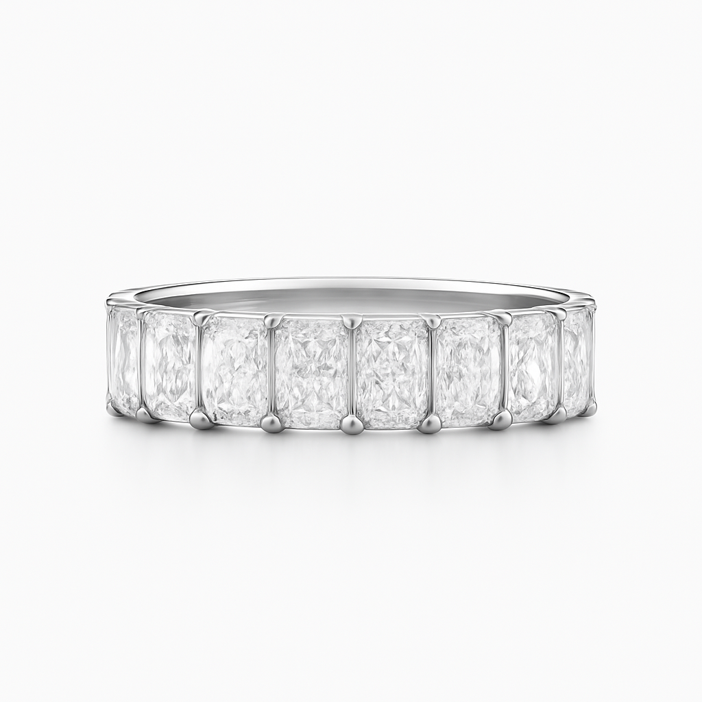 Diamond ring with emerald-cut stones on a white background