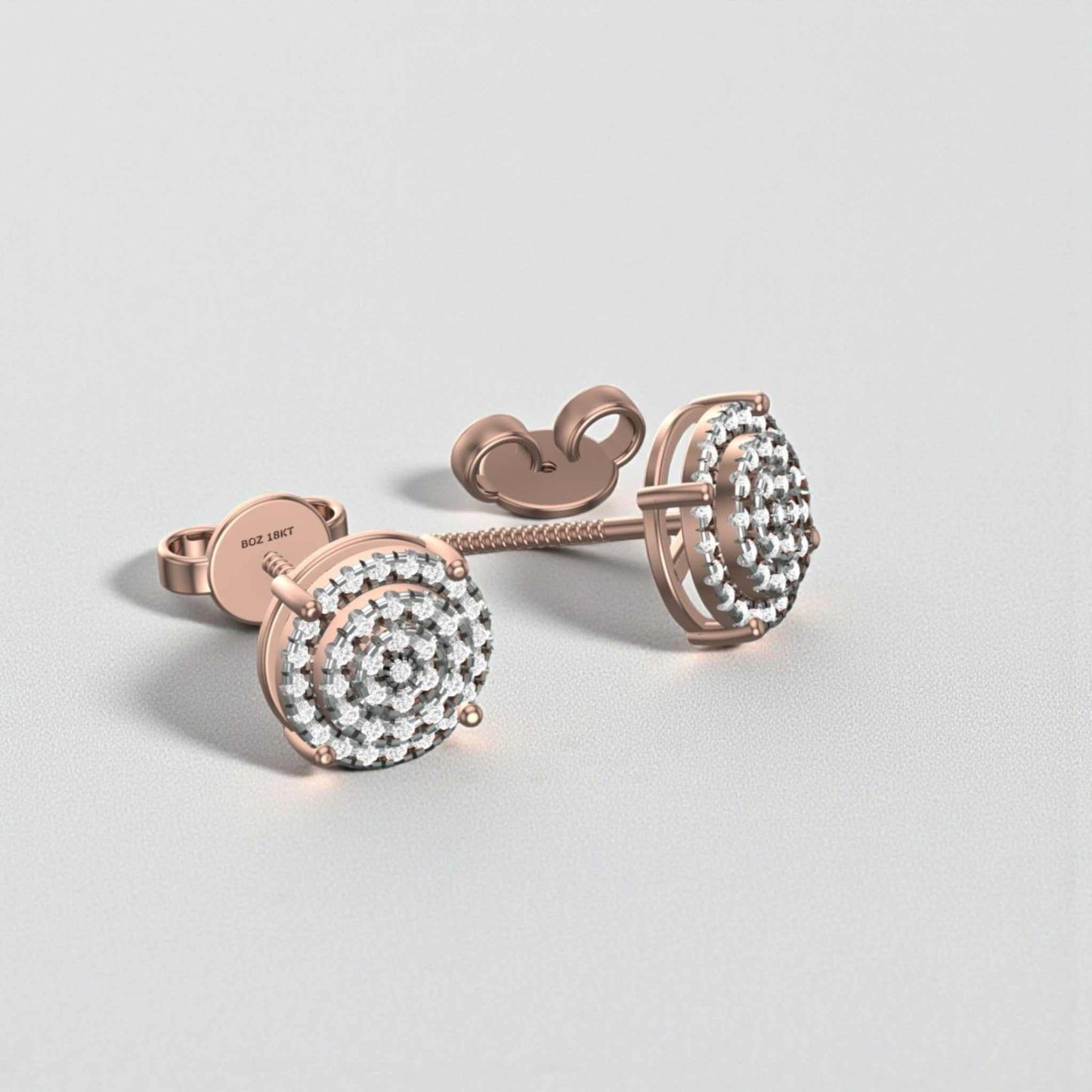 Rose gold earrings with clear gemstones on a light gray background