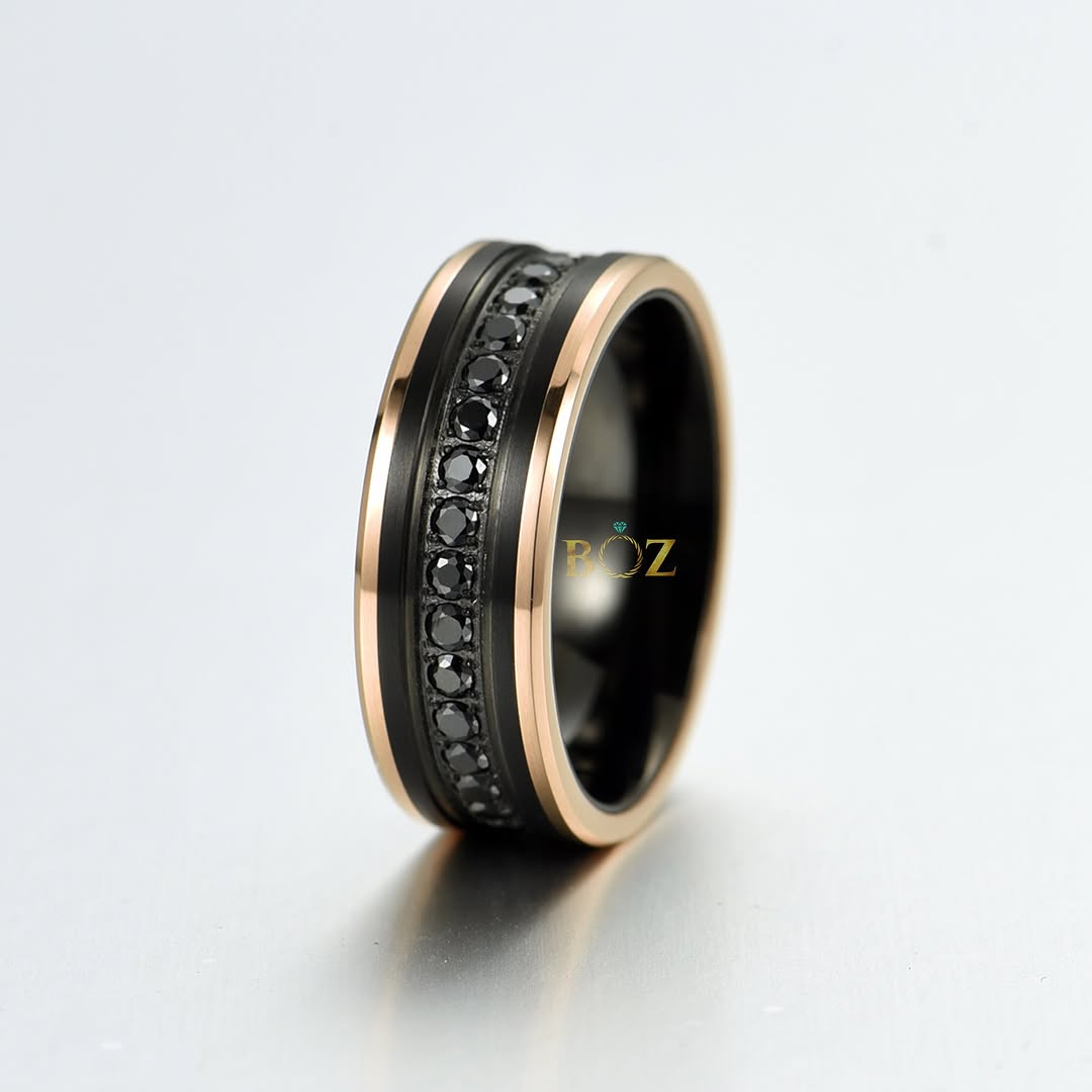 A black tungsten carbide band featuring black sapphire gemstones set on the sides, with a rose gold edge.