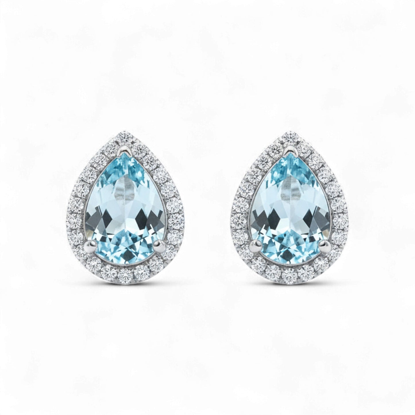 Teardrop-shaped earrings with blue gemstones on a white background