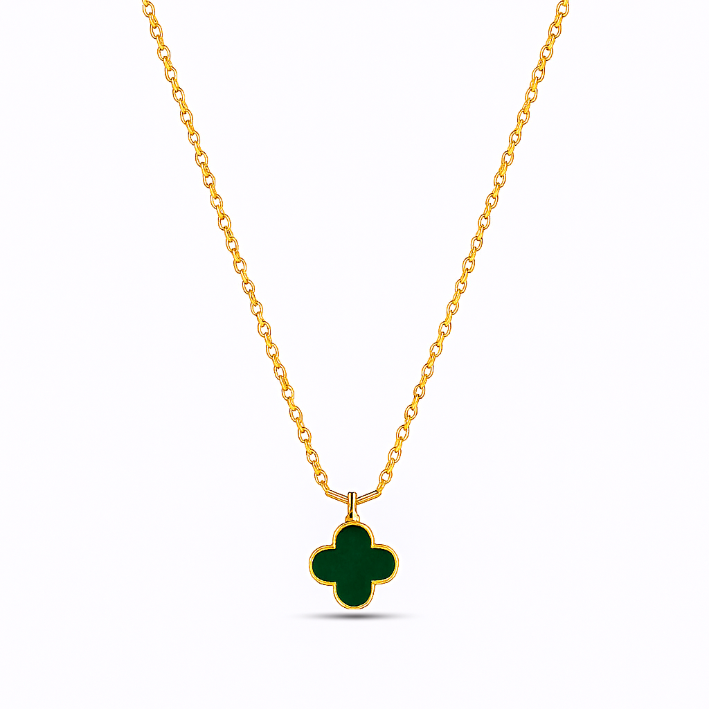 Gold necklace with a green clover pendant on a white background