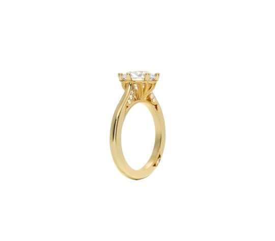 Gold ring with a diamond on a white background