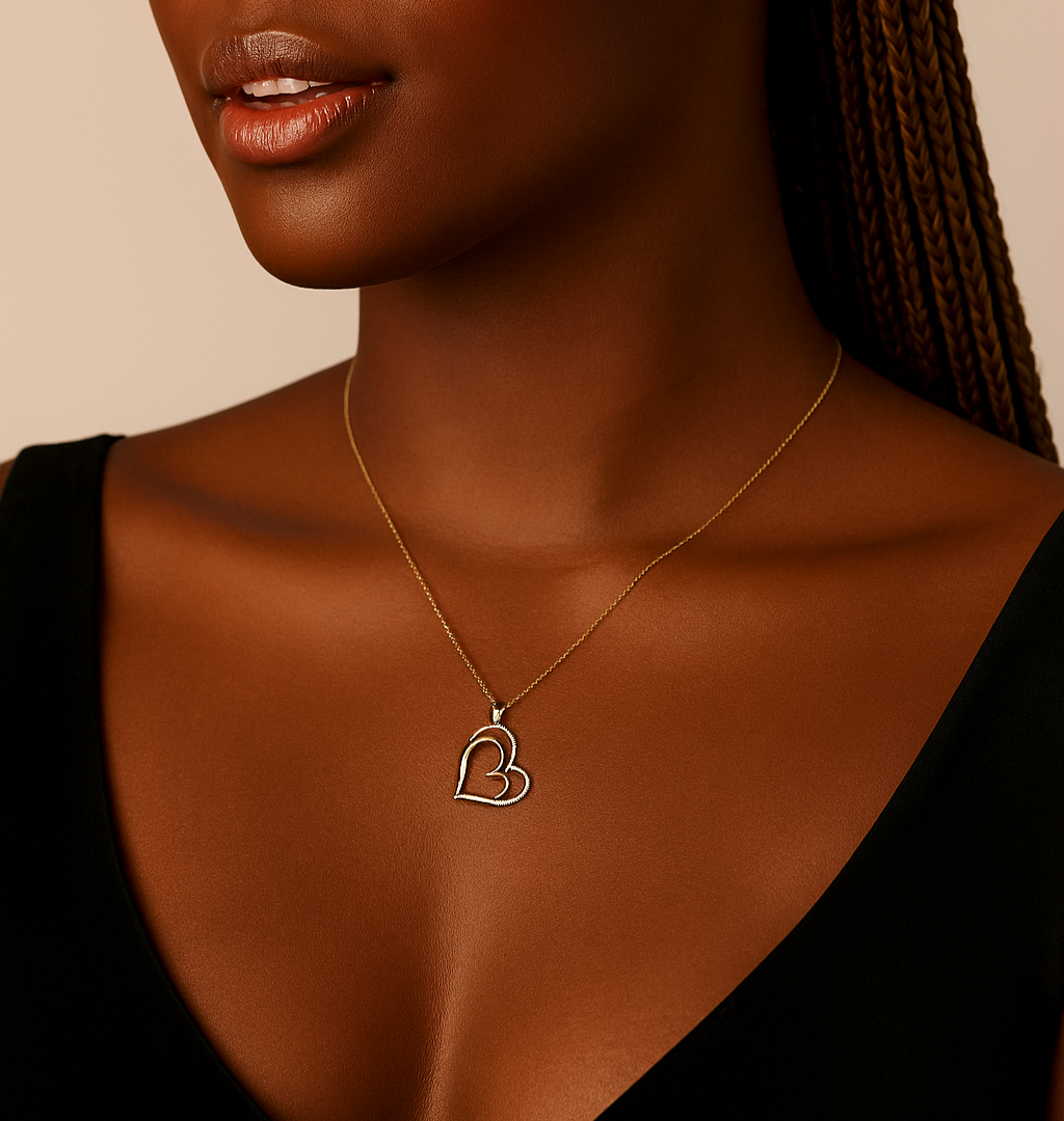 Woman wearing a necklace with a heart pendant, branded as BOZ Jewelry.
