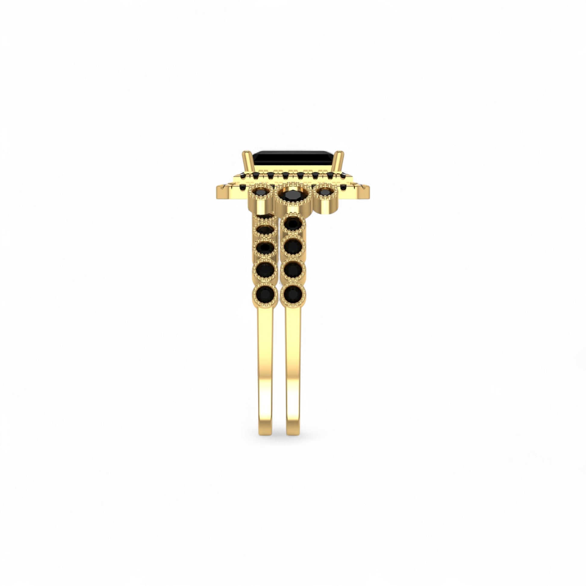 Gold ring with black gemstones on a white background