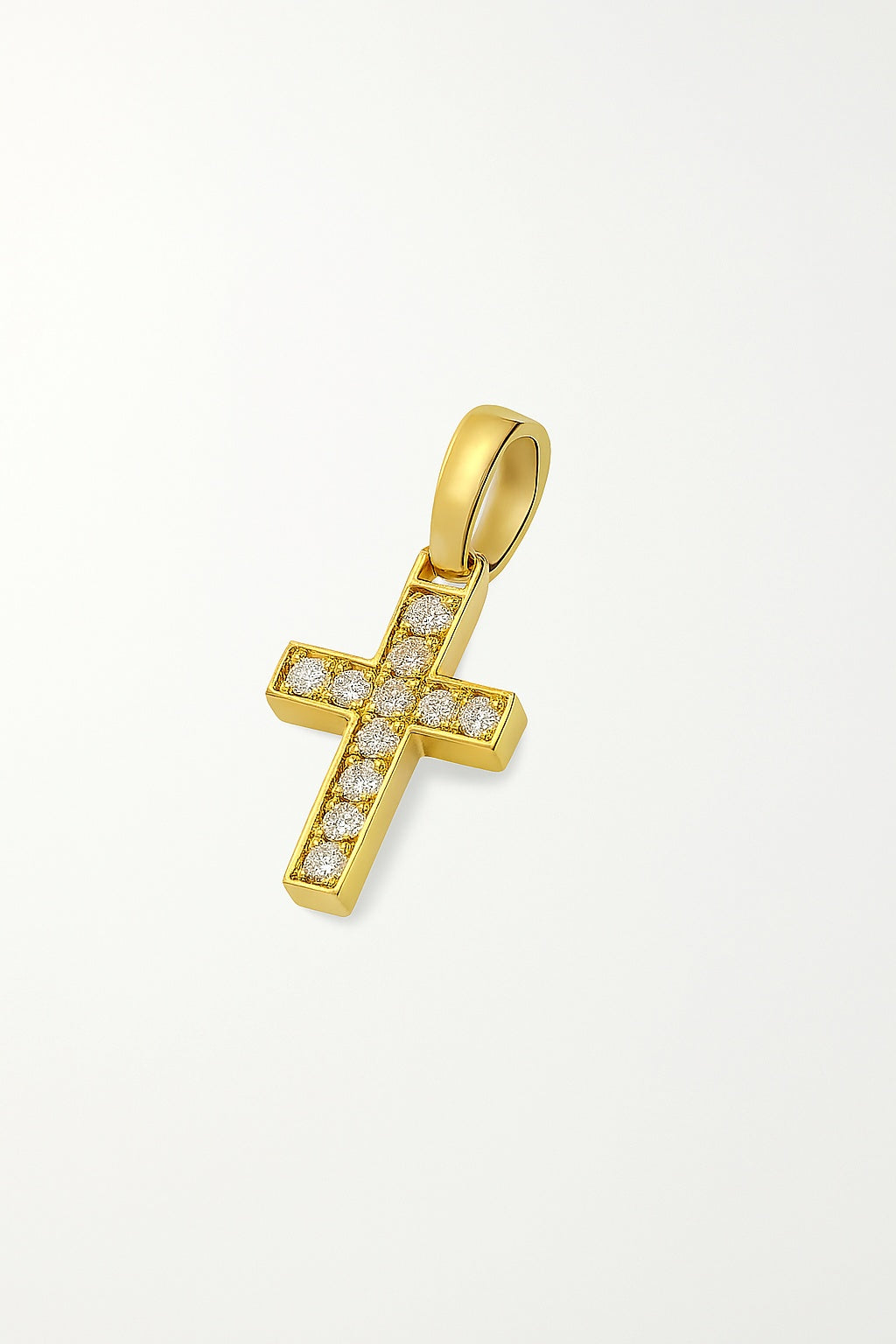 Gold cross pendant with embedded diamonds on a light gray background