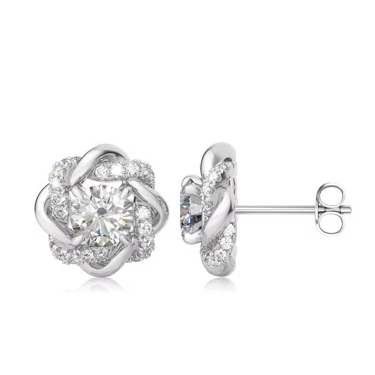 Silver earrings with clear gemstones on a white background