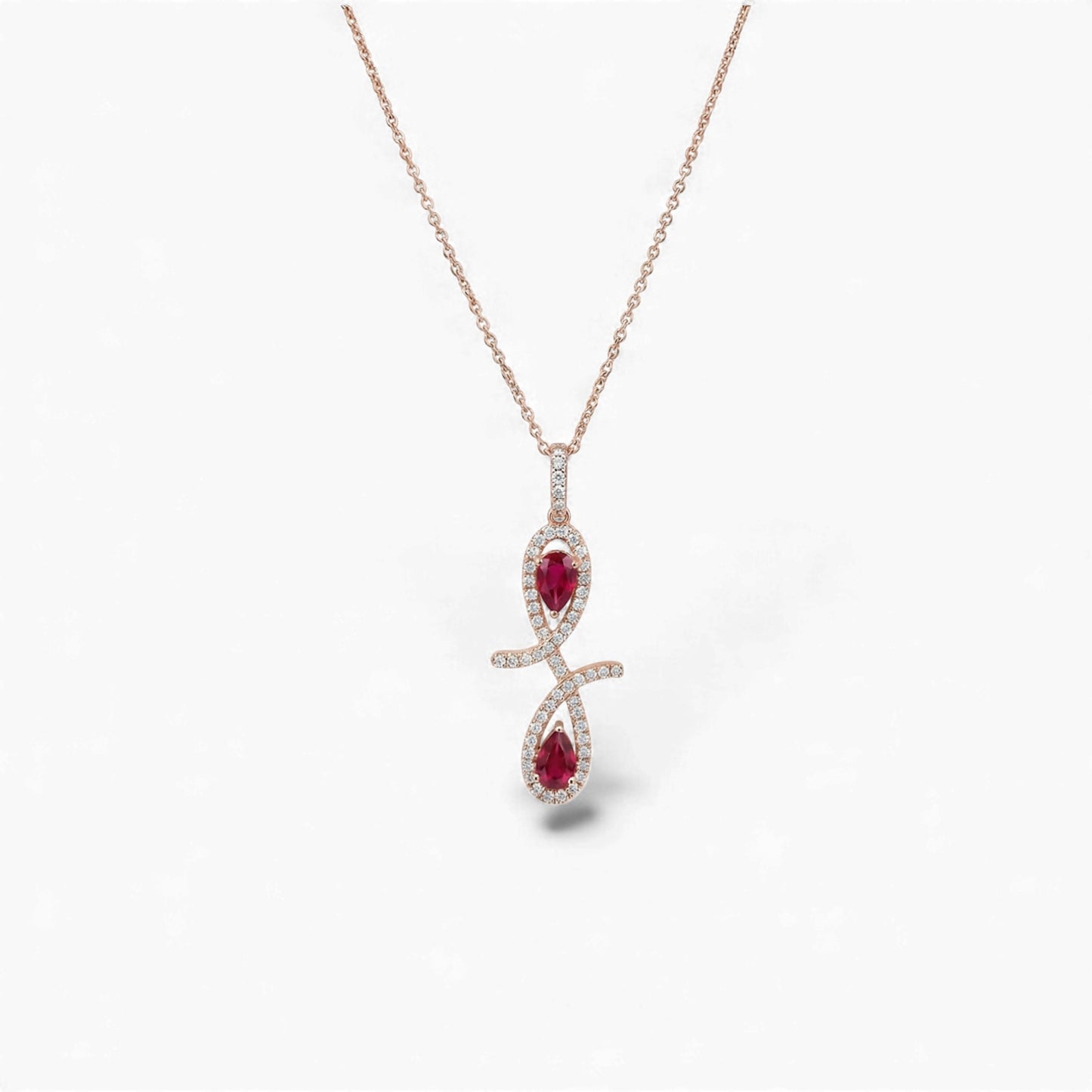 Rose gold necklace with a red gemstone pendant on a white background