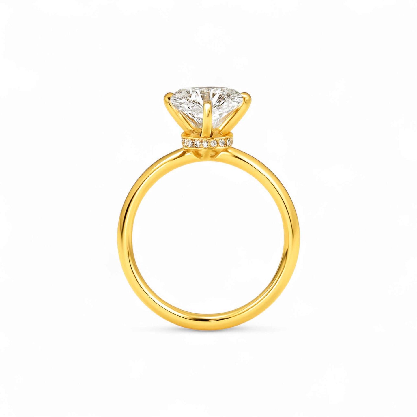 Phoebe Moissanite Engagement Ring featuring a solitaire VVS1 D moissanite set in polished 18K gold with a hidden halo accent.